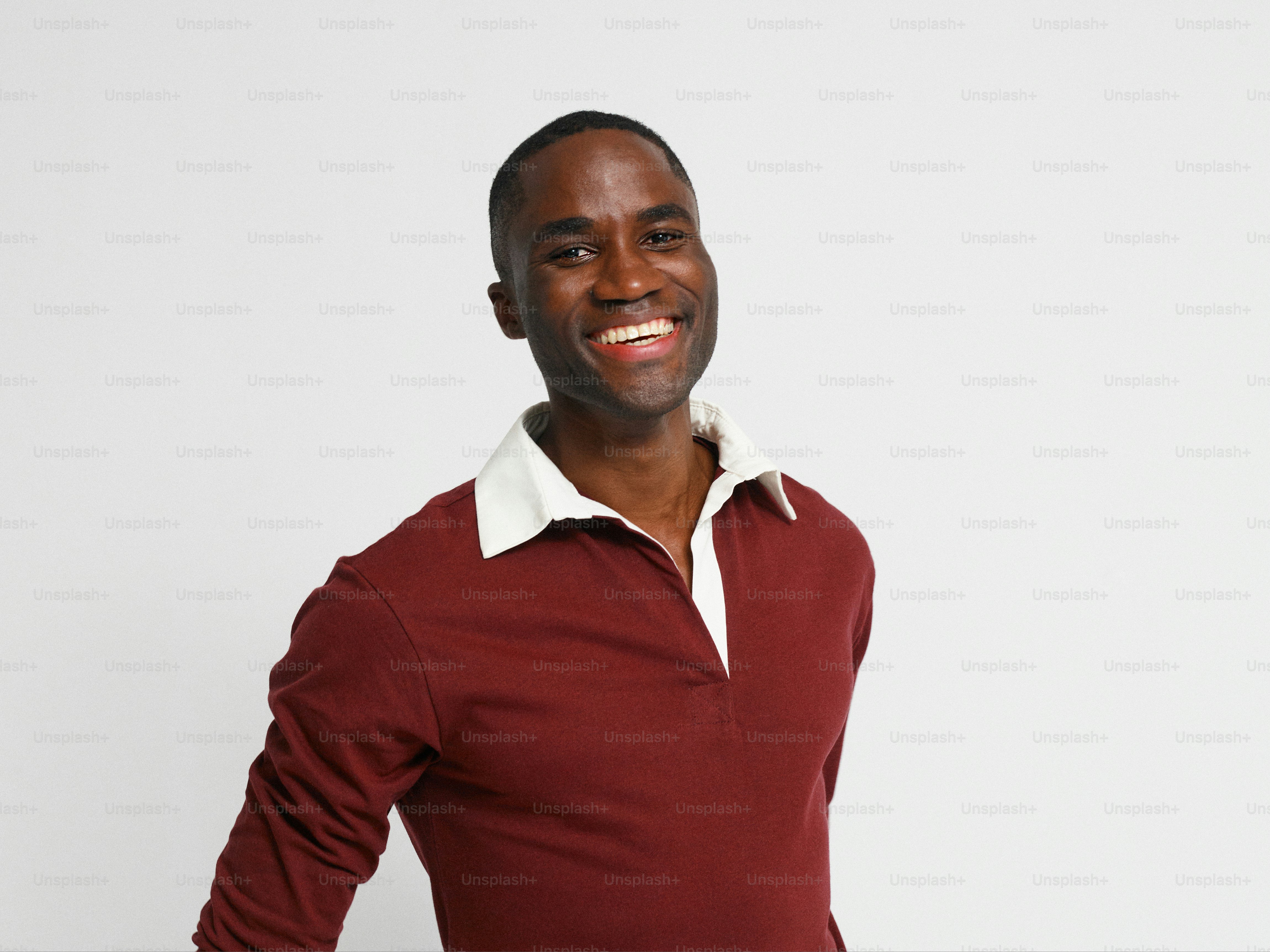 Un homme en chemise rouge sourit