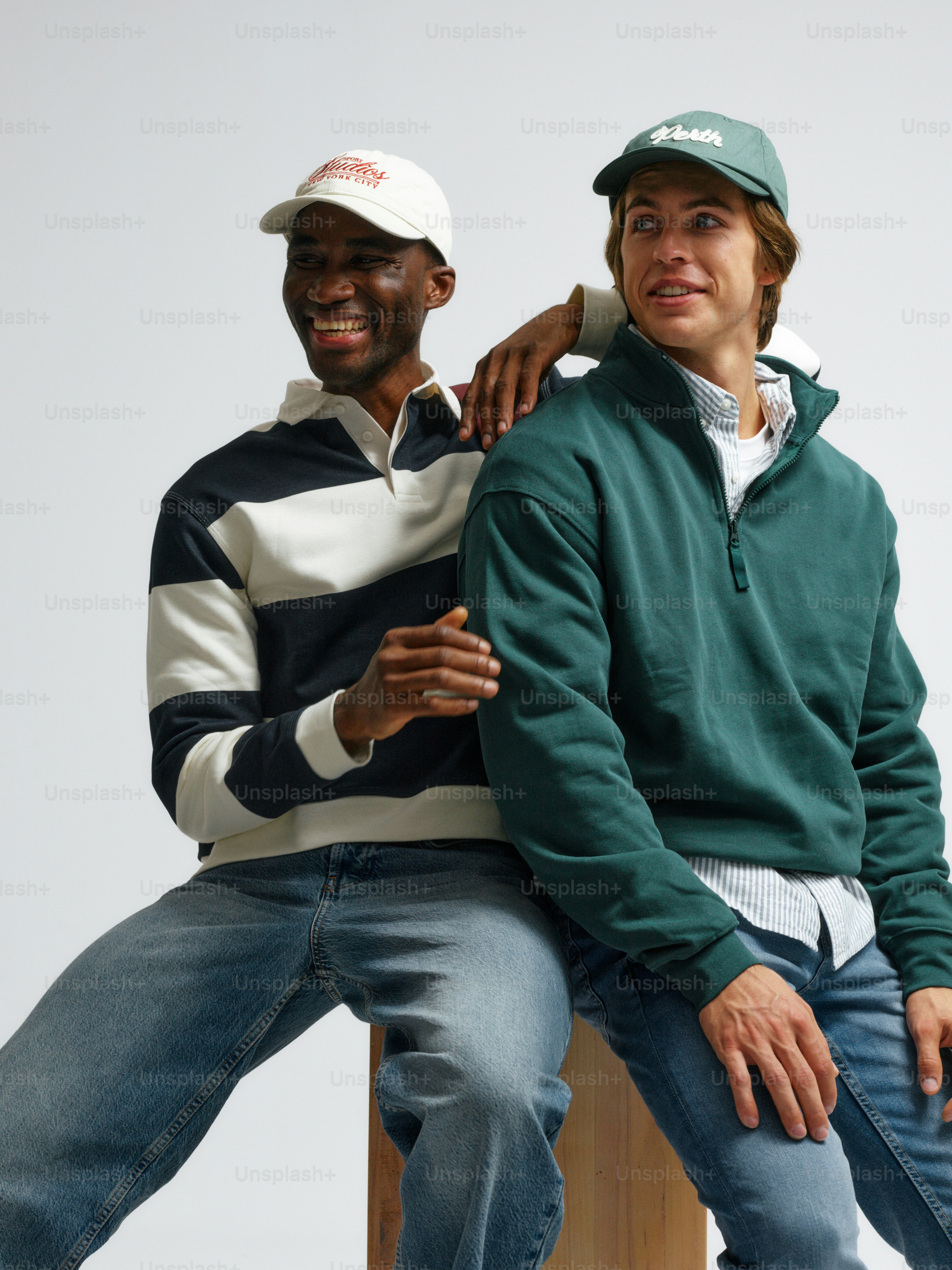 A couple of men sitting on top of a wooden bench