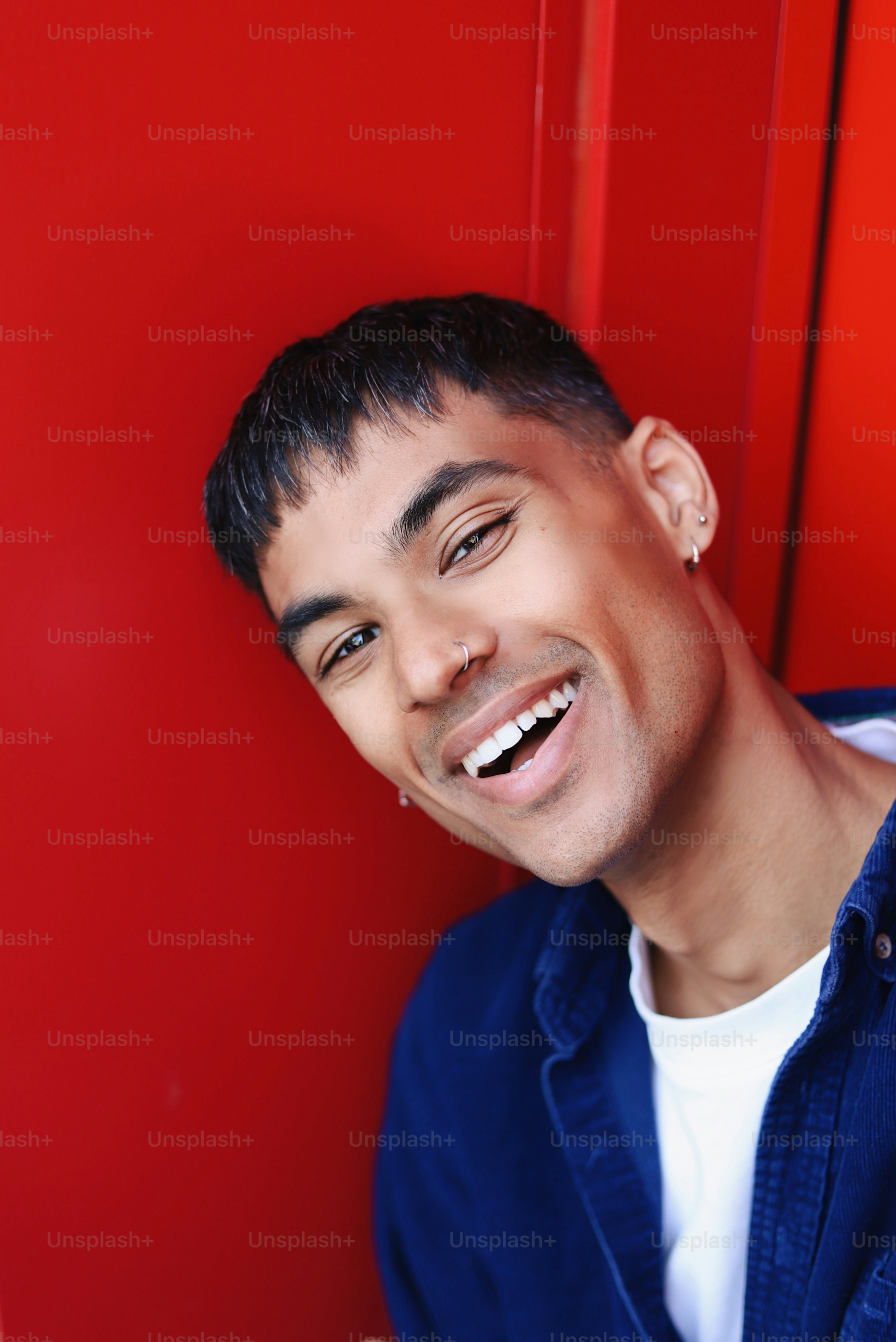 A man smiling while holding a cell phone