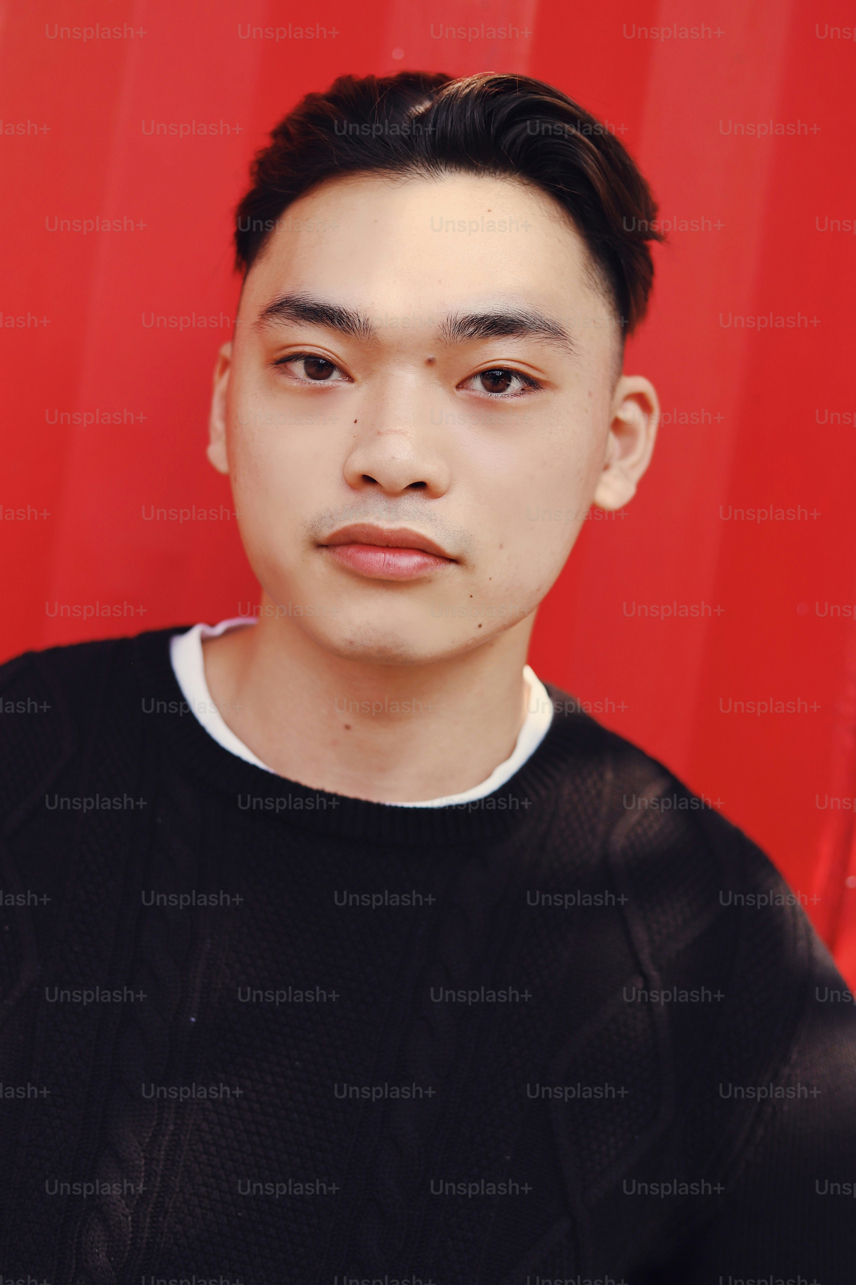 A man standing in front of a red wall