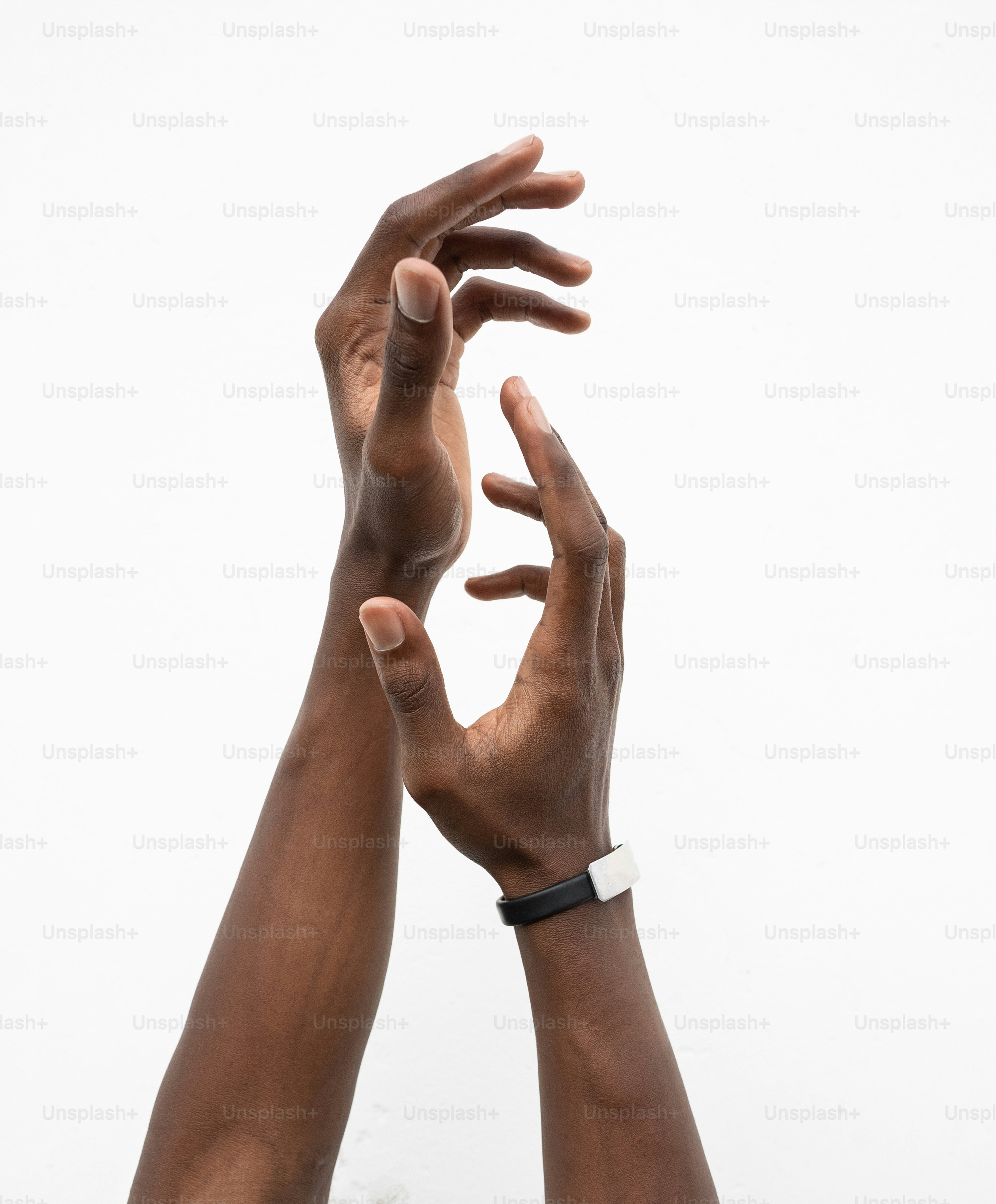 Two hands reaching up into the air
