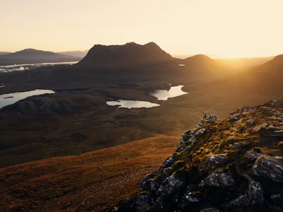 Person on mountain at sunset