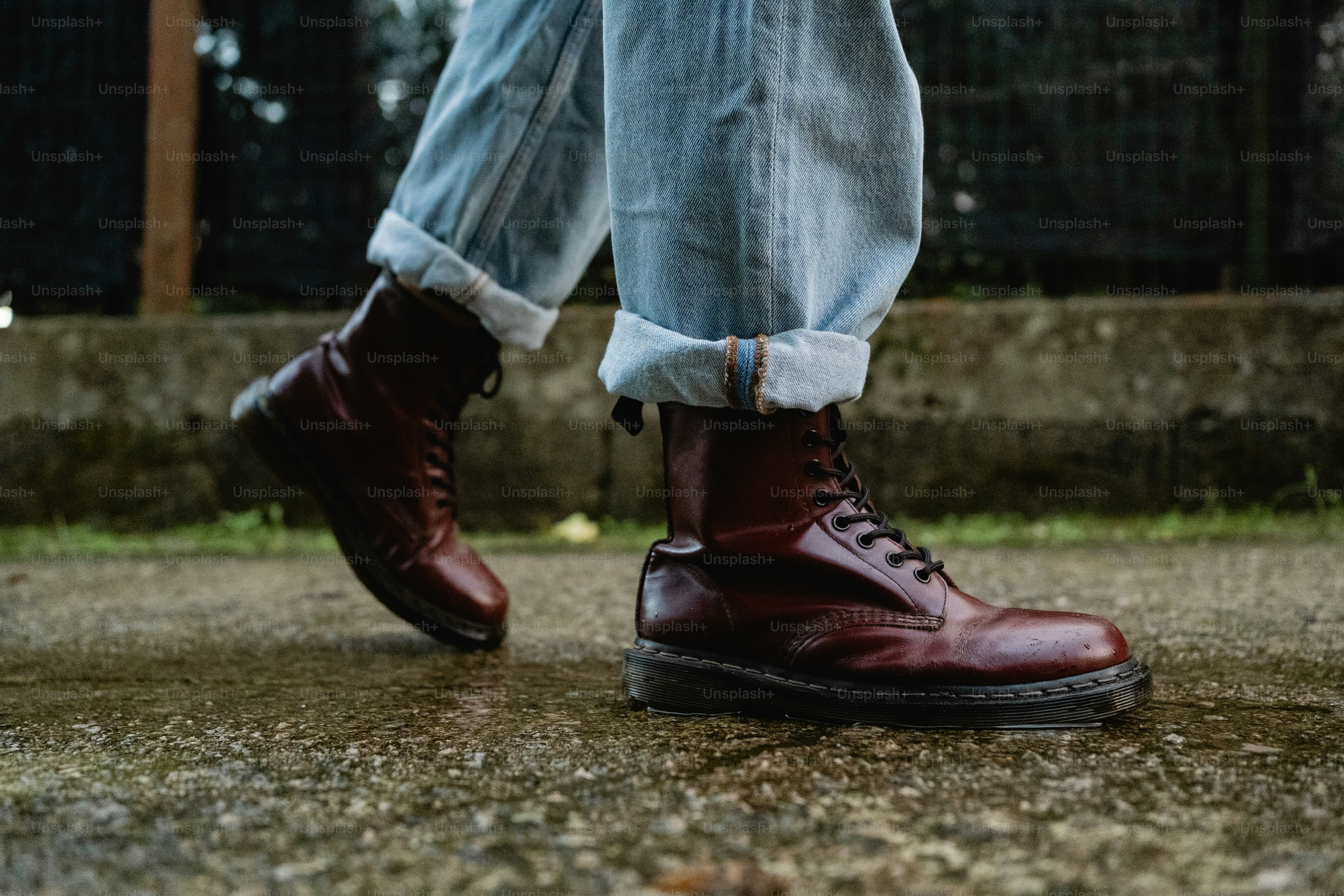 A person wearing red shoes walking on a sidewalk