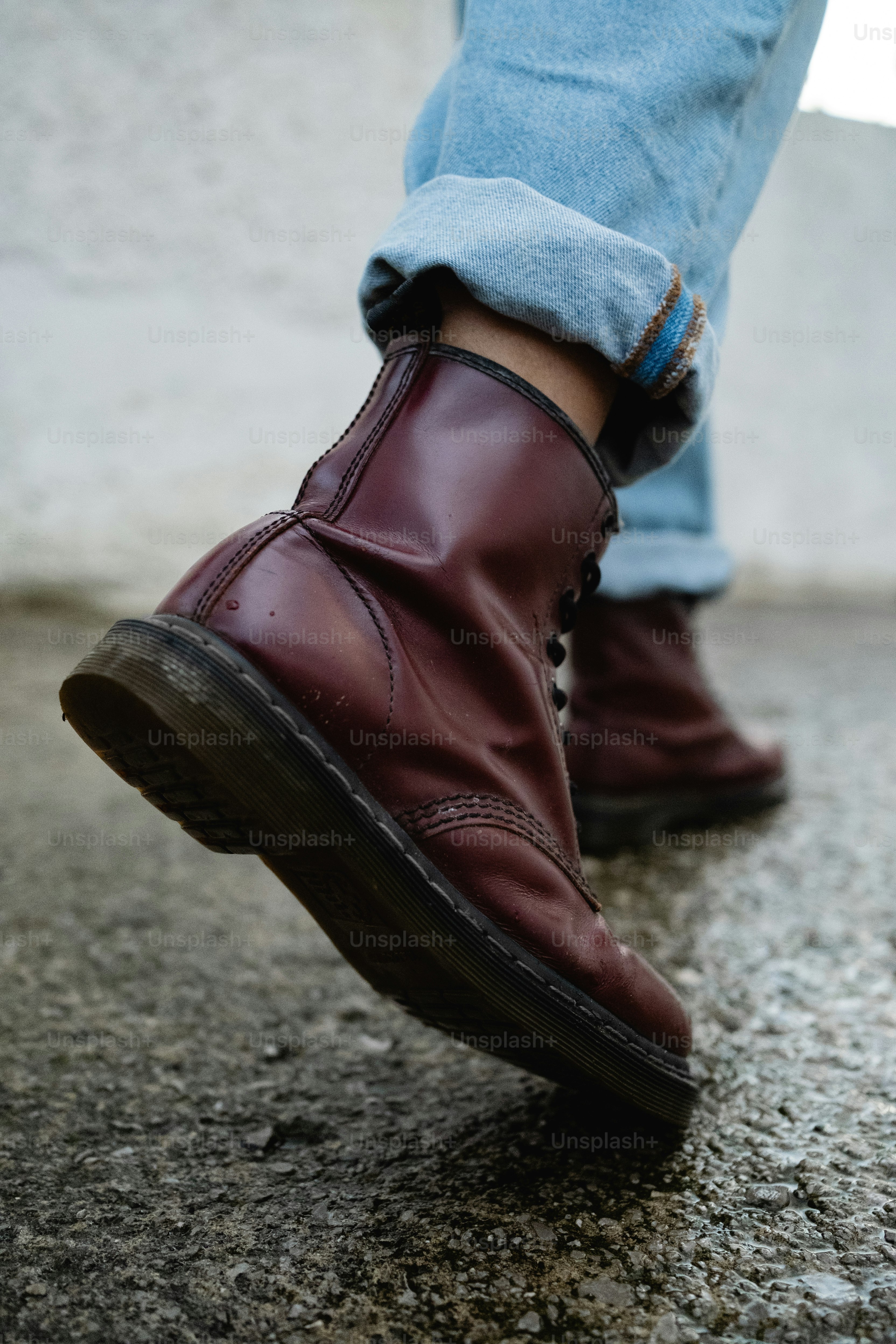 A close up of a person wearing a pair of boots