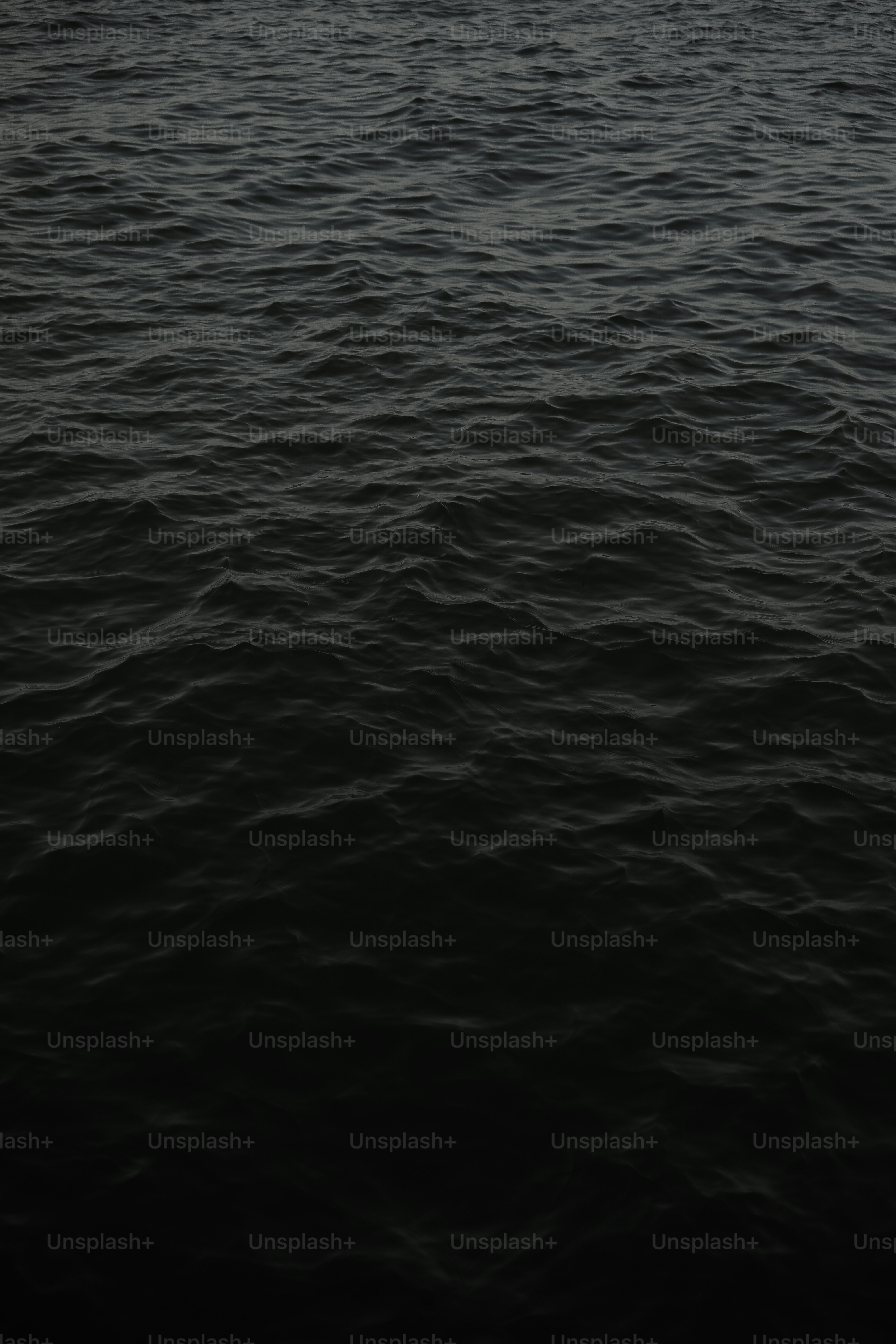 A large body of water with a boat in the distance