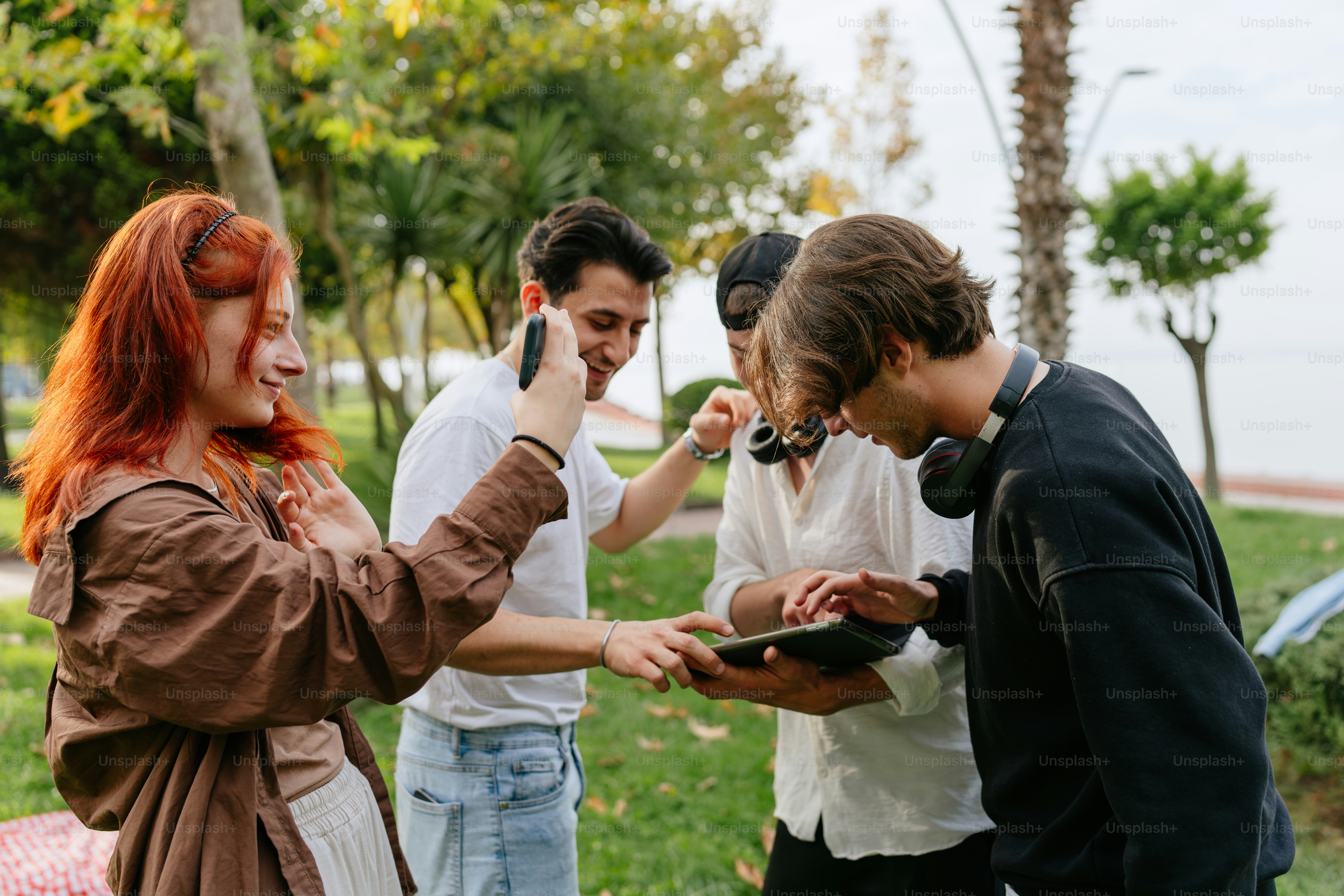 A group of people standing around each other photo – Friendship Image ...