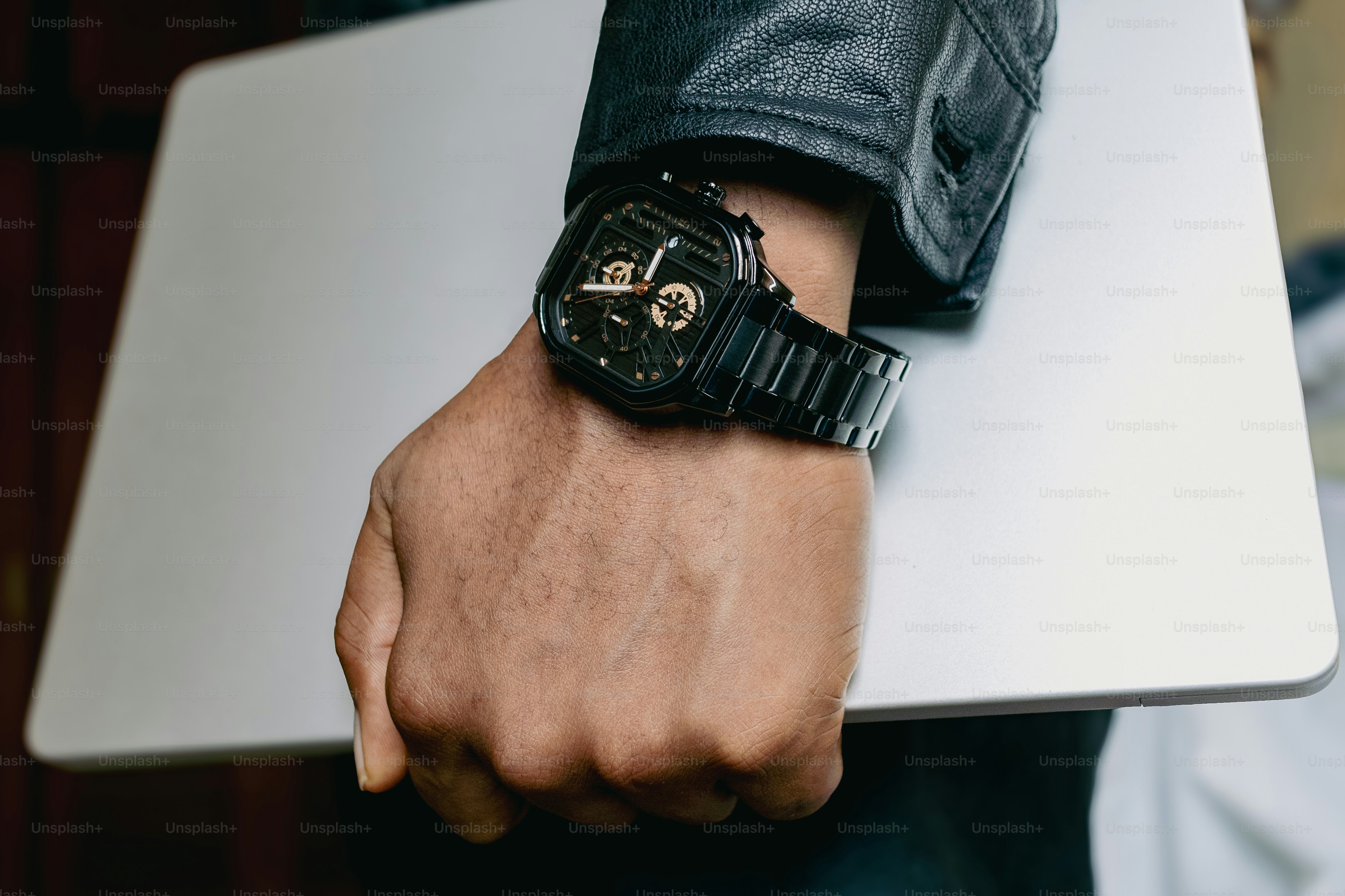 A close up of a person holding a laptop