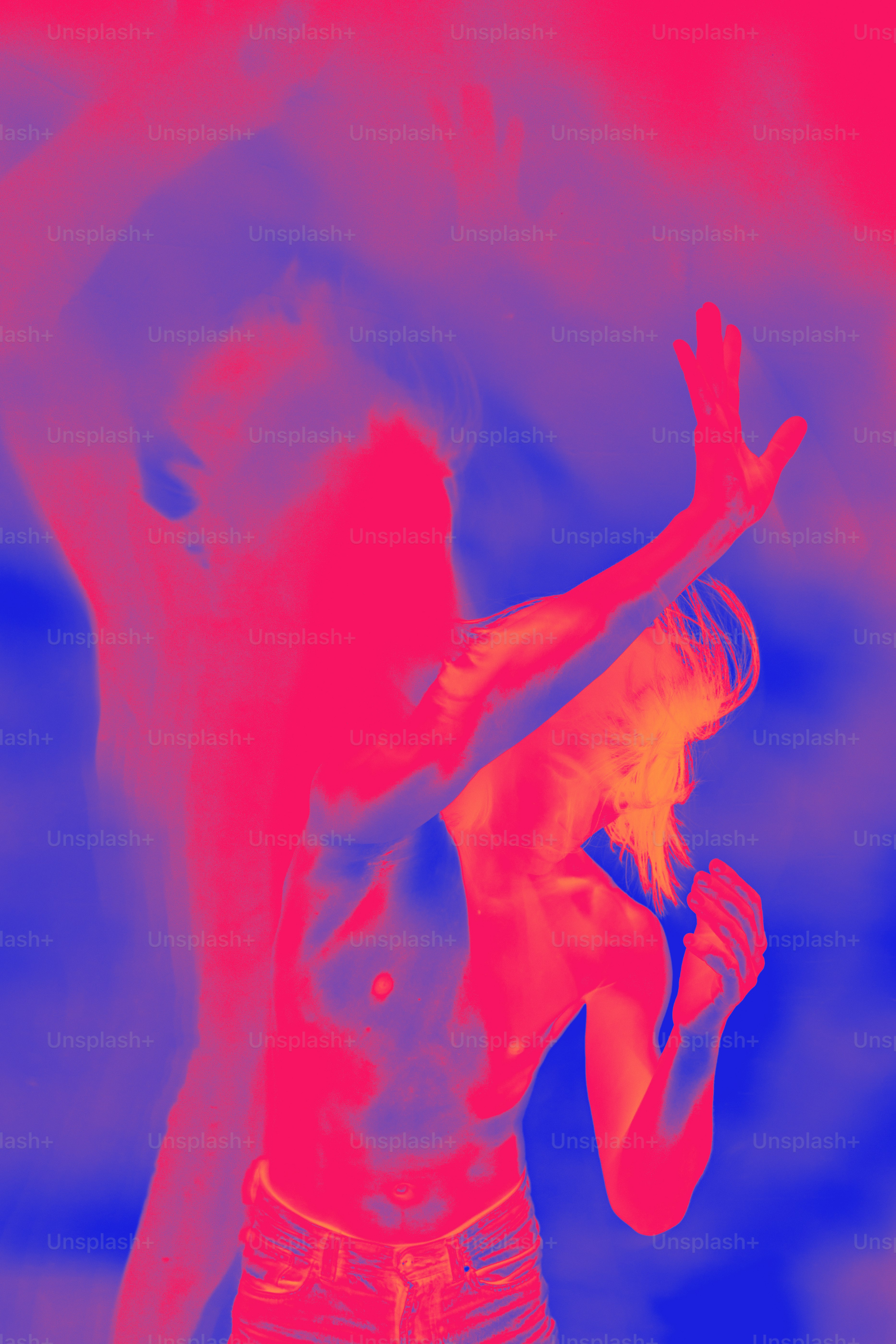 A man and a woman standing in front of a red and blue background