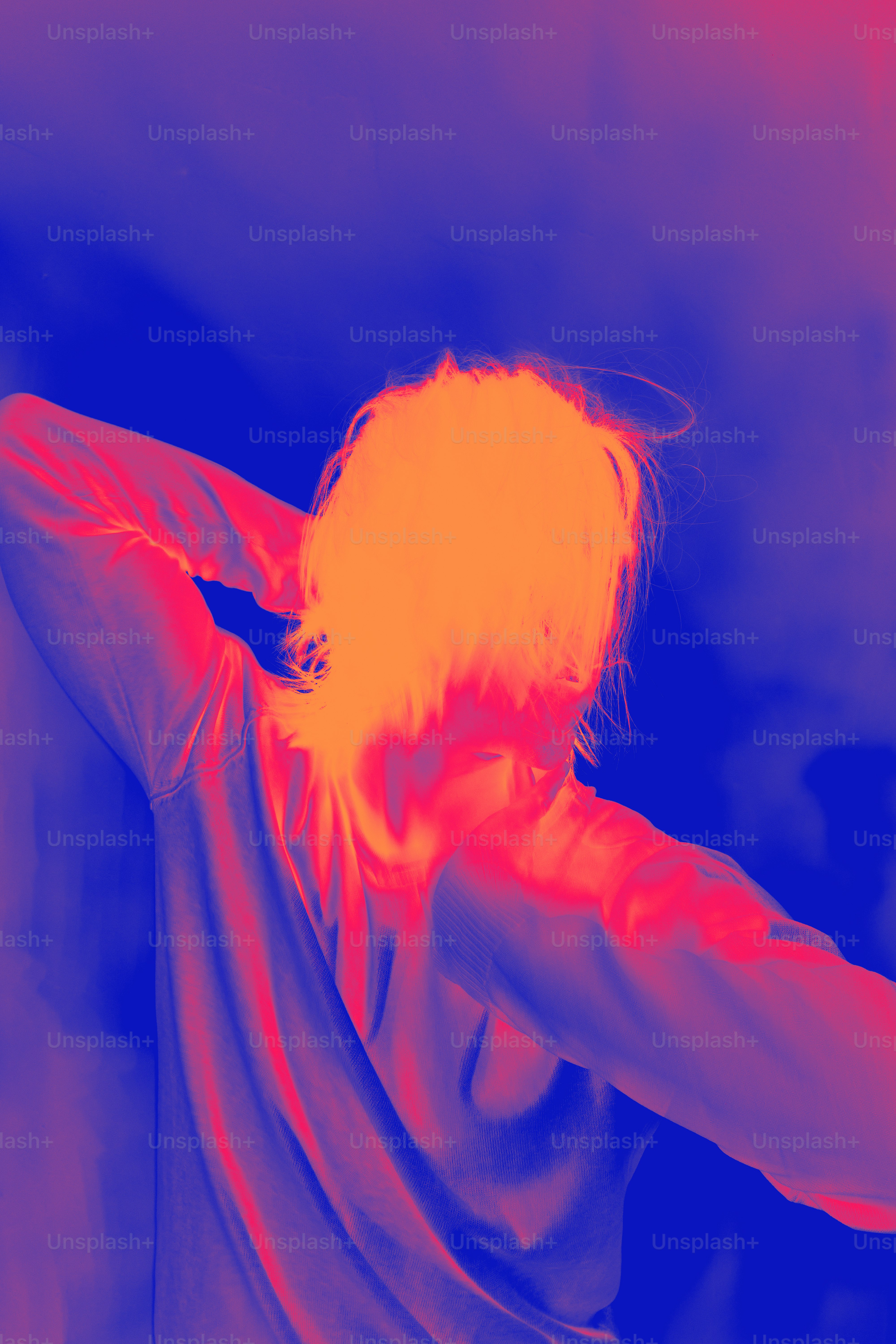 A man with white hair and a white beard wearing a red and blue shirt