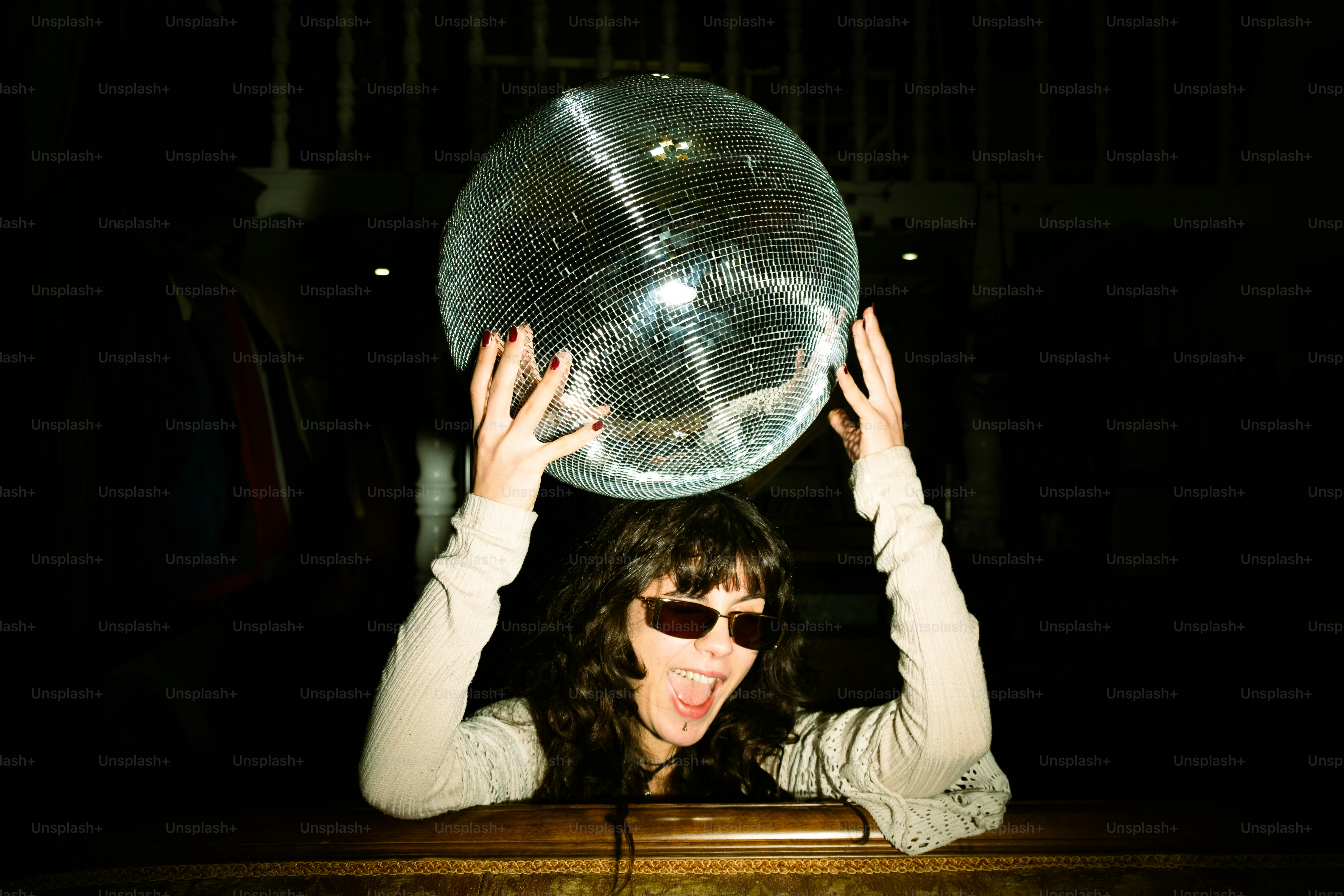 A woman holding a large bubble above her head
