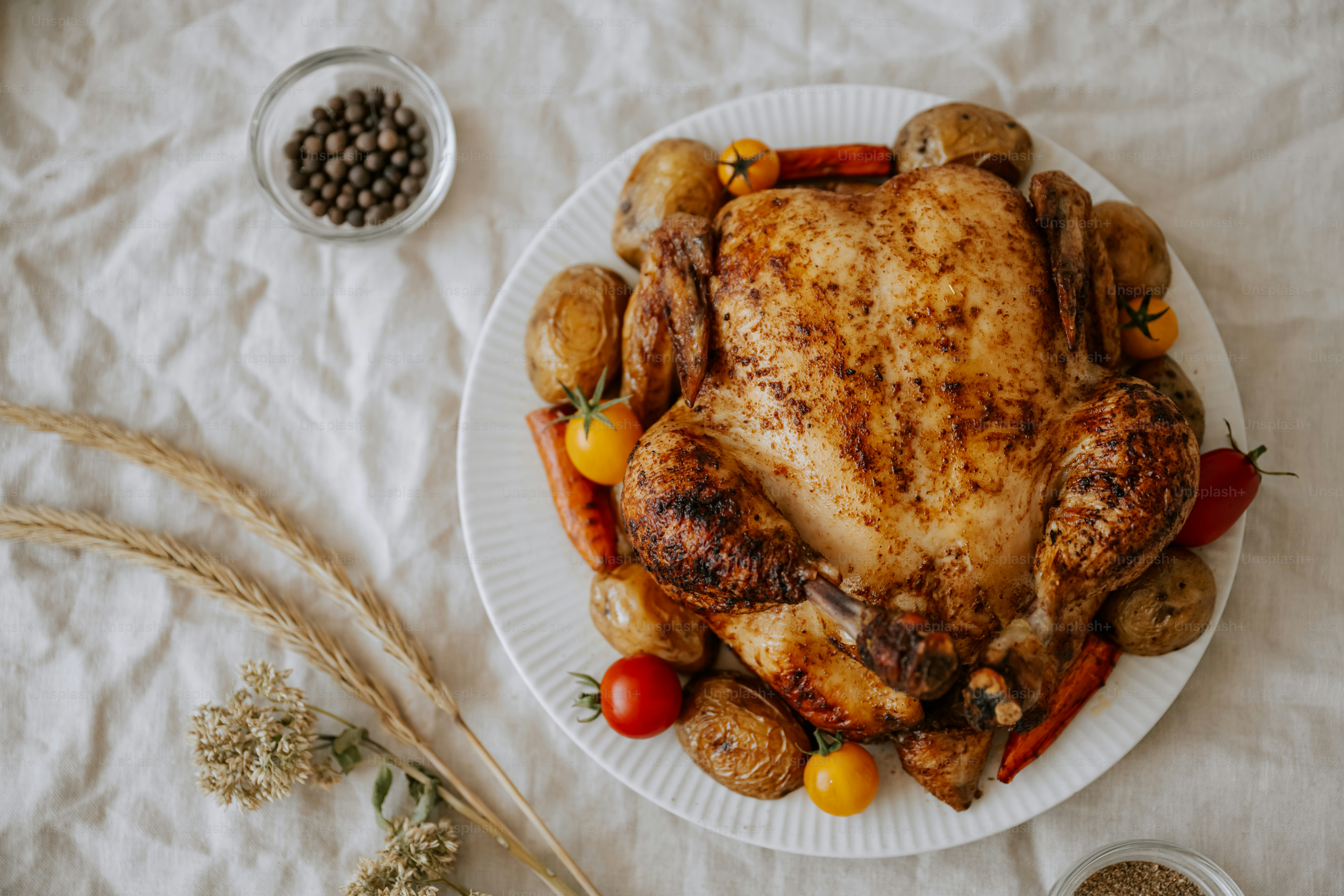 A white plate topped with a chicken and vegetables