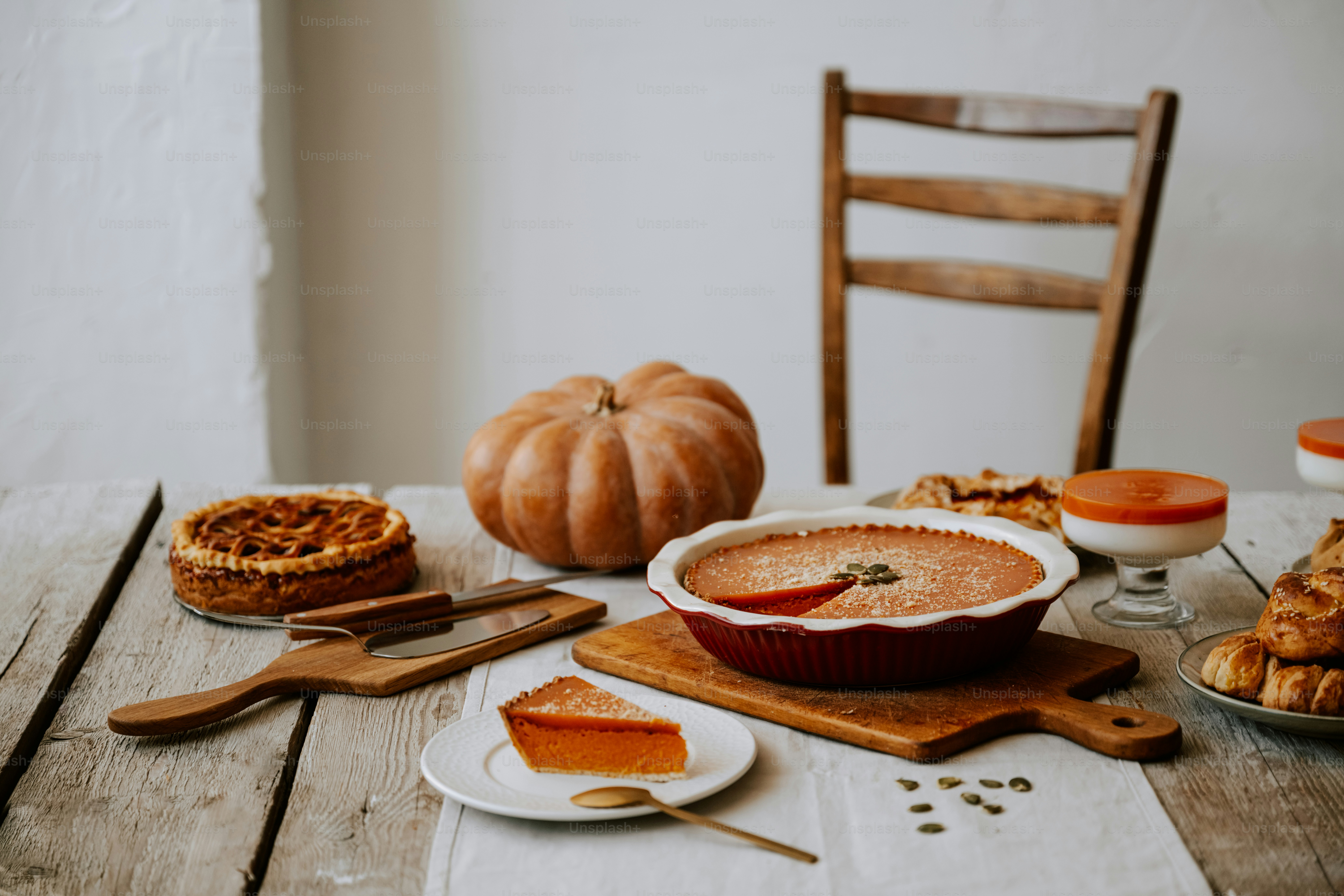 A wooden table topped with pies and pie crusts photo – Seasonal Image ...