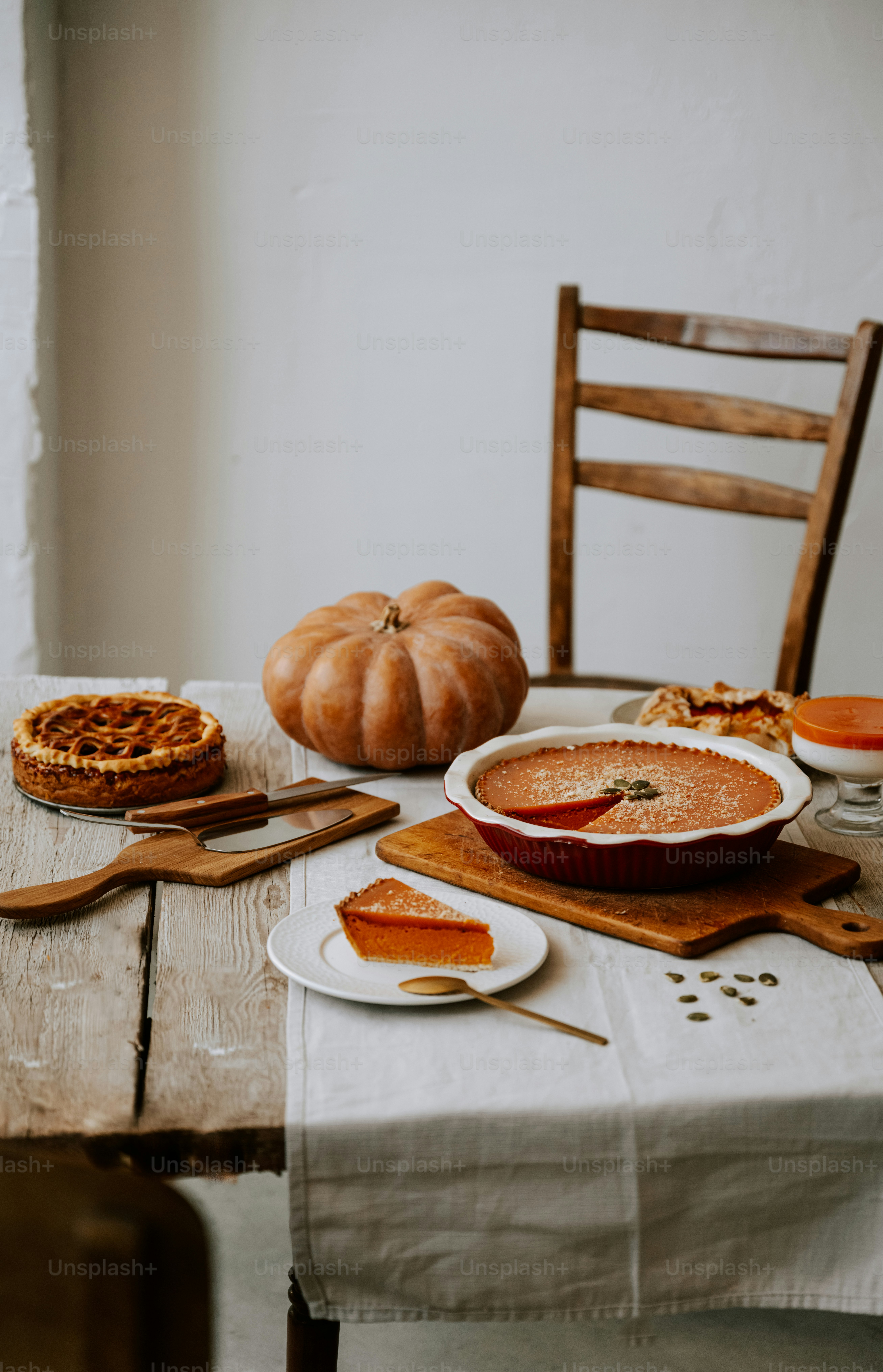 A wooden table topped with a bowl of soup