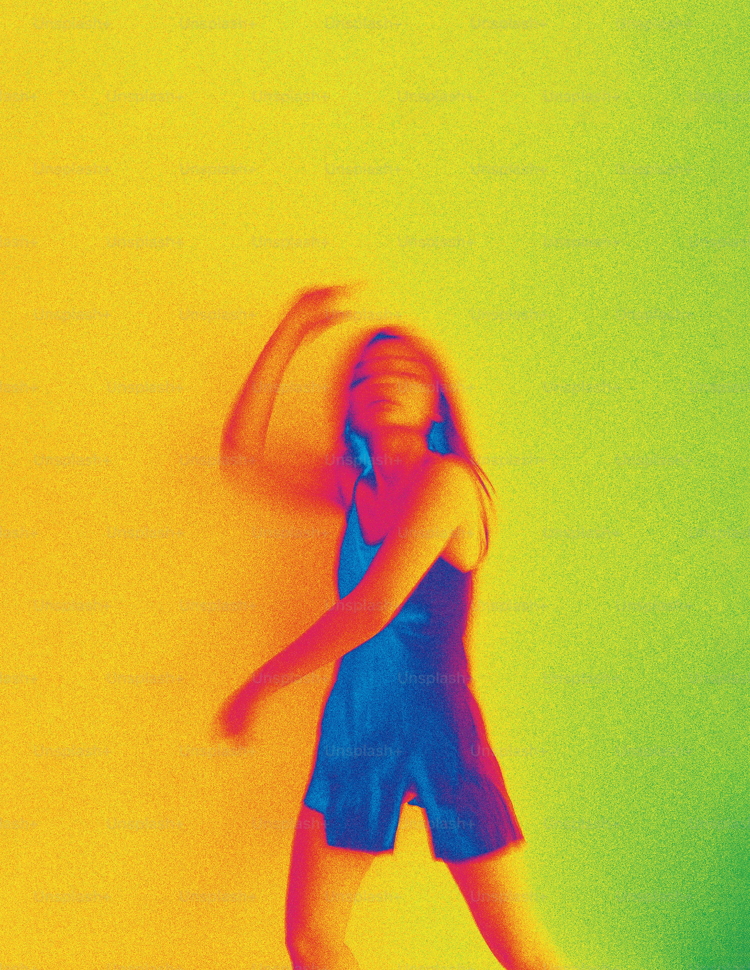 A girl standing in front of a yellow wall
