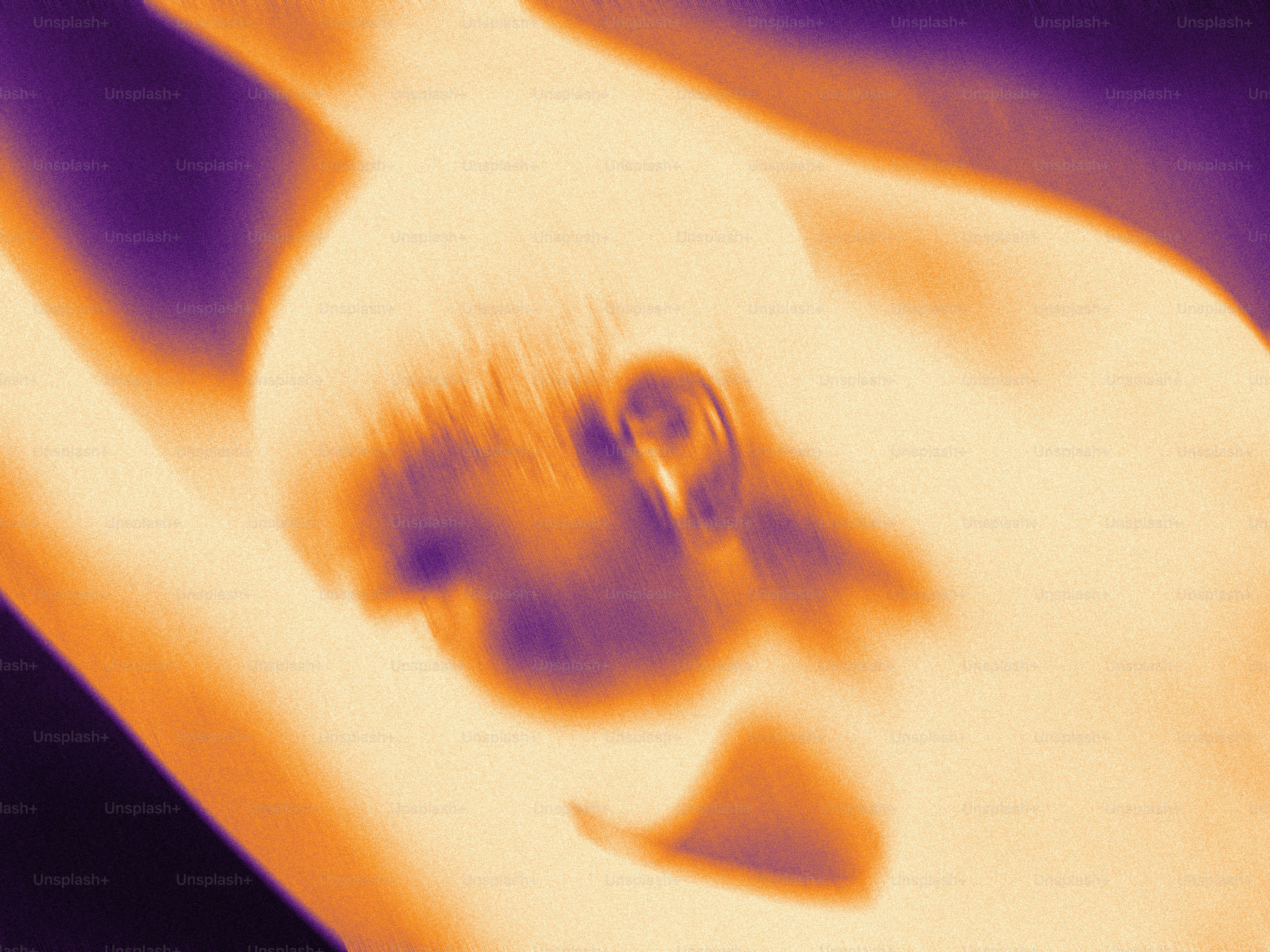 A blurry image of a person holding a cell phone