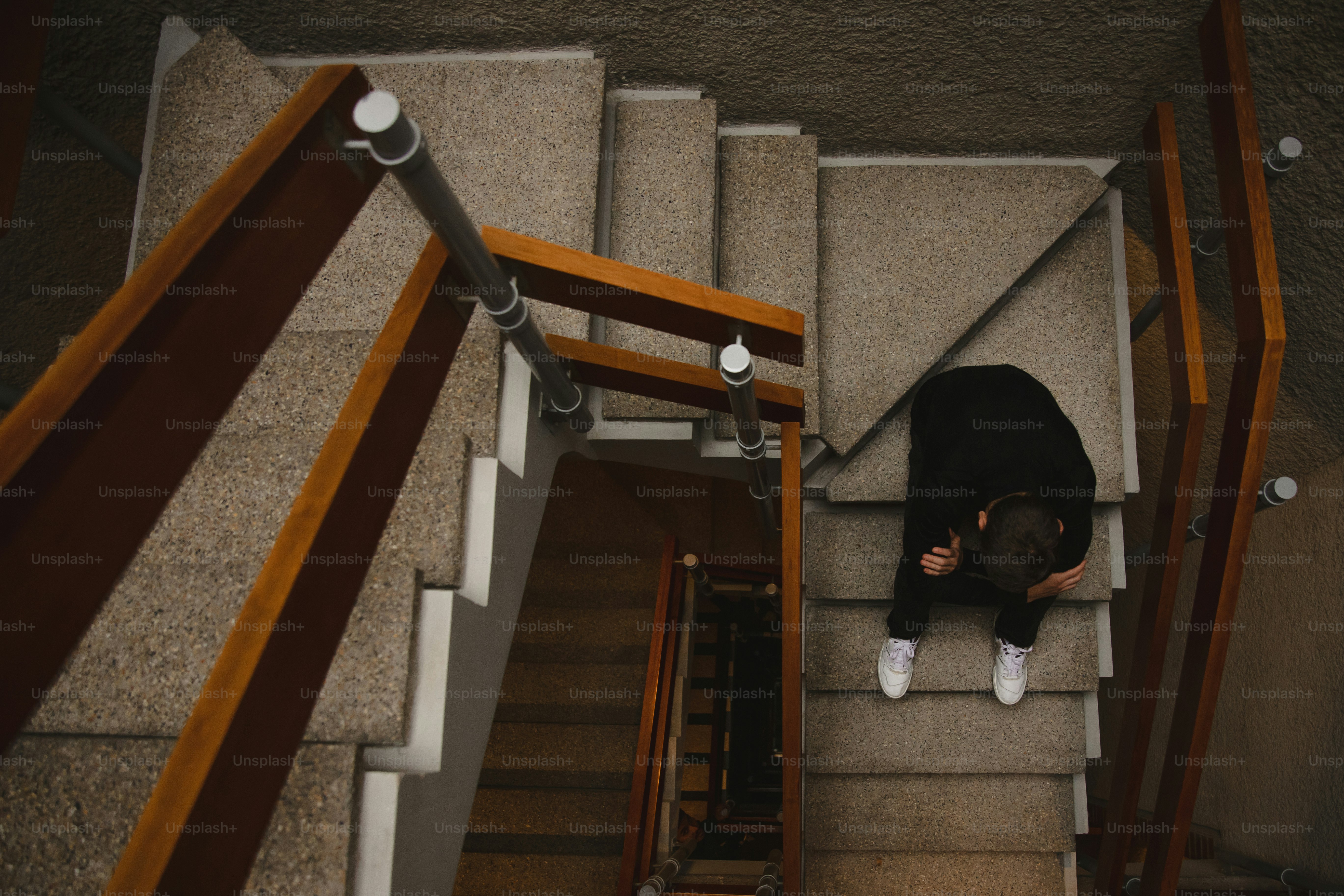 A person sitting on the stairs of a building