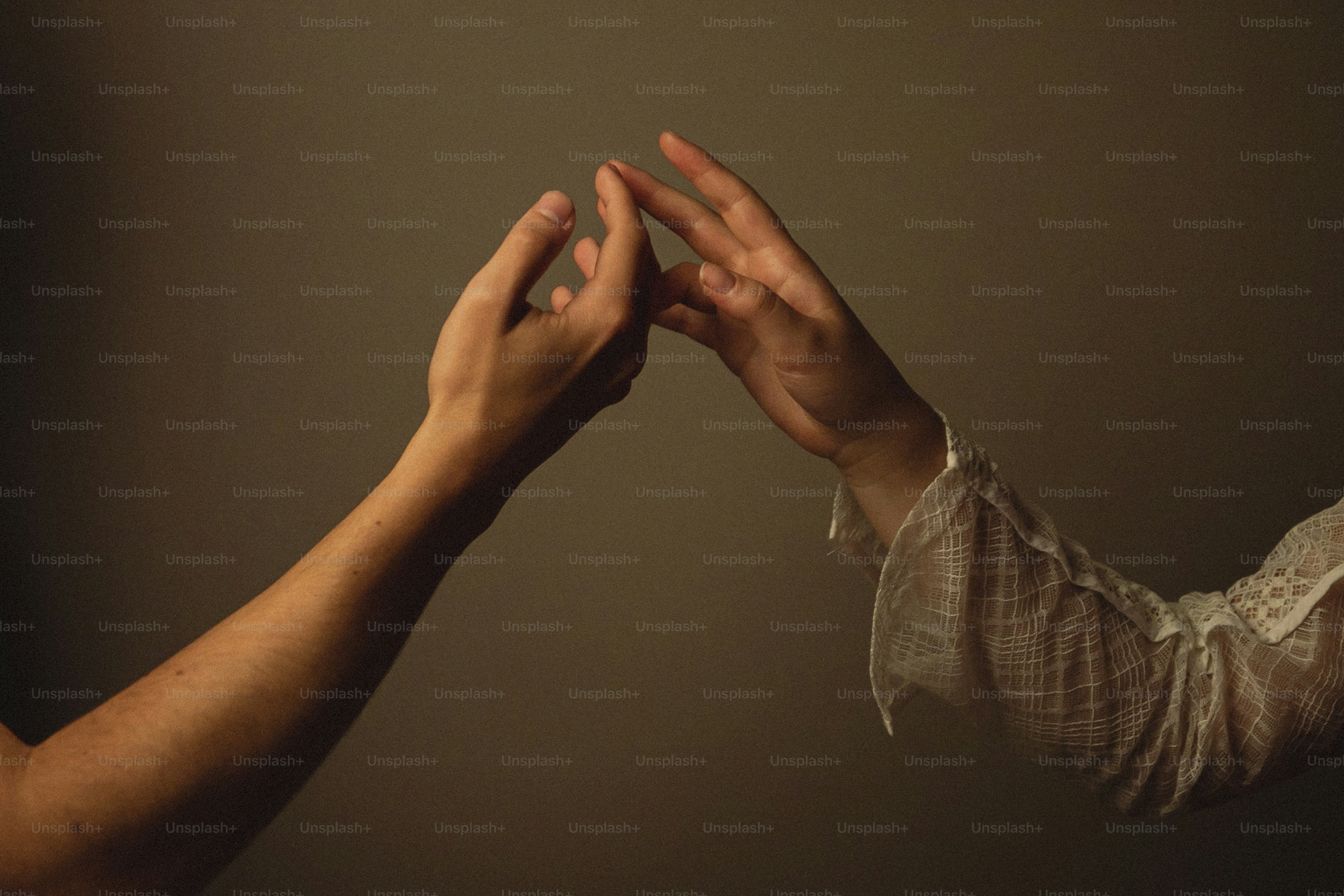 Two hands reaching out towards each other