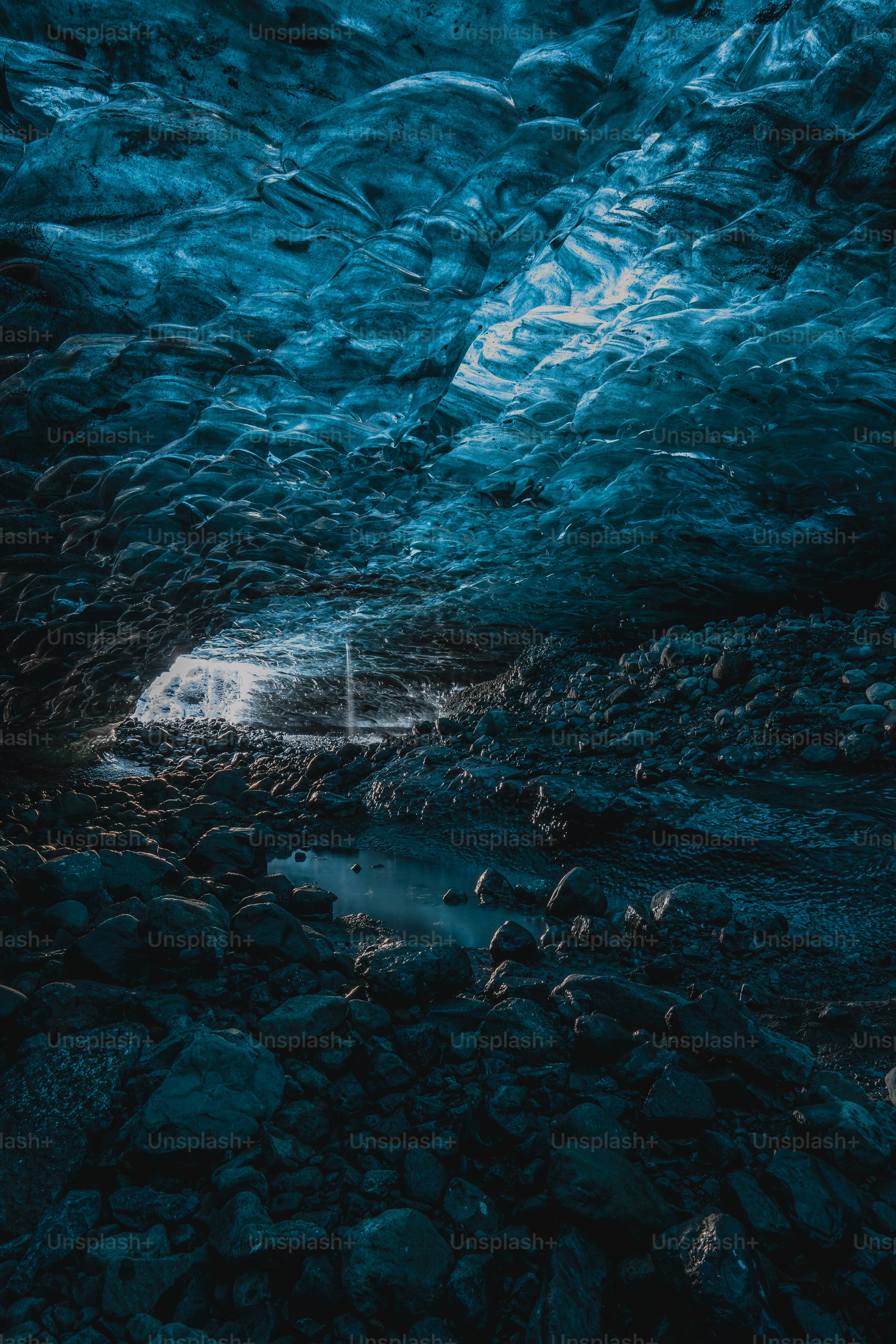 A cave filled with lots of rocks and water