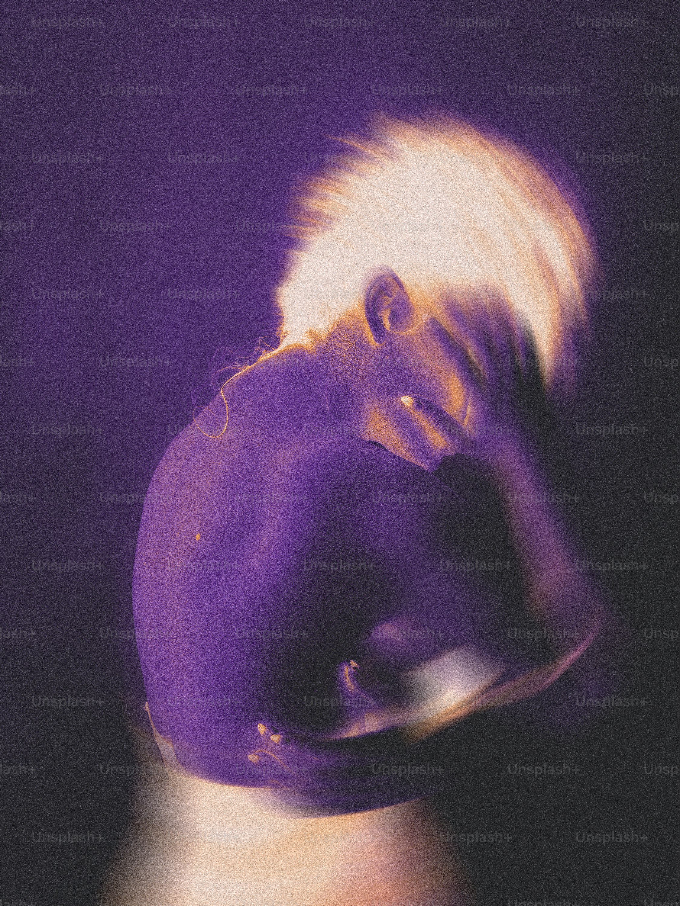 A blurry image of a person with a purple hat