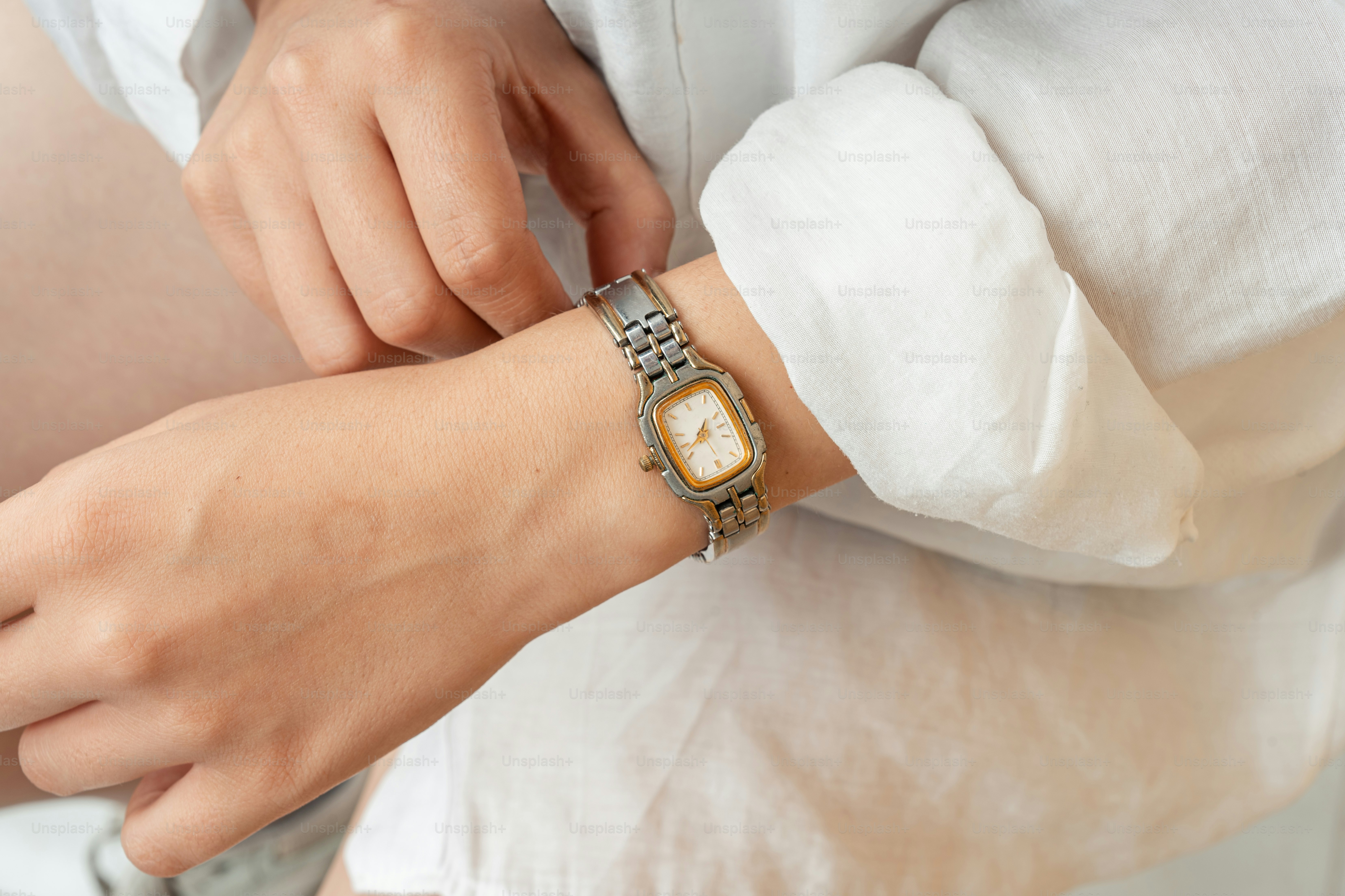 A pregnant woman wearing a watch on her wrist