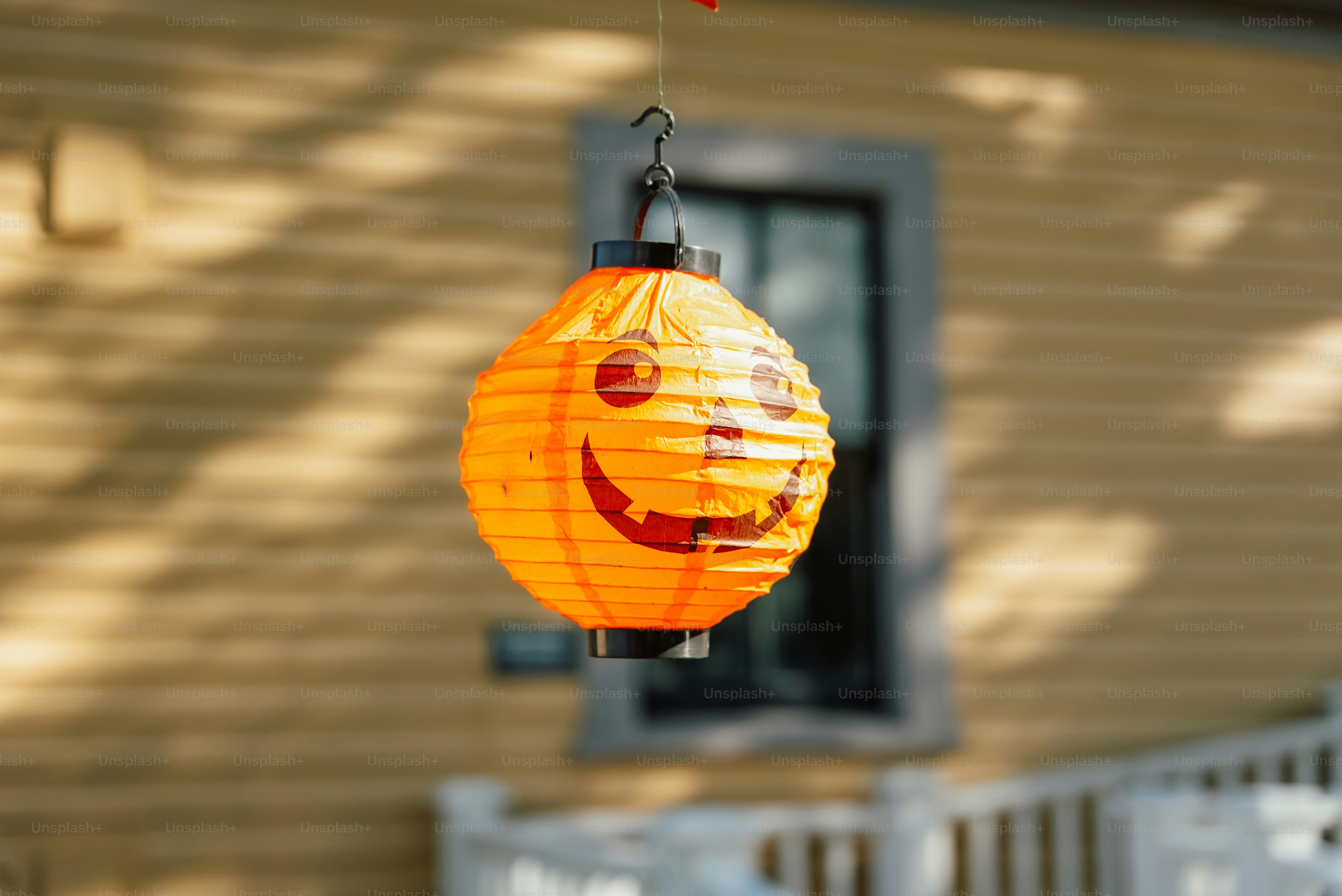 A yellow lantern with a smiley face hanging from it