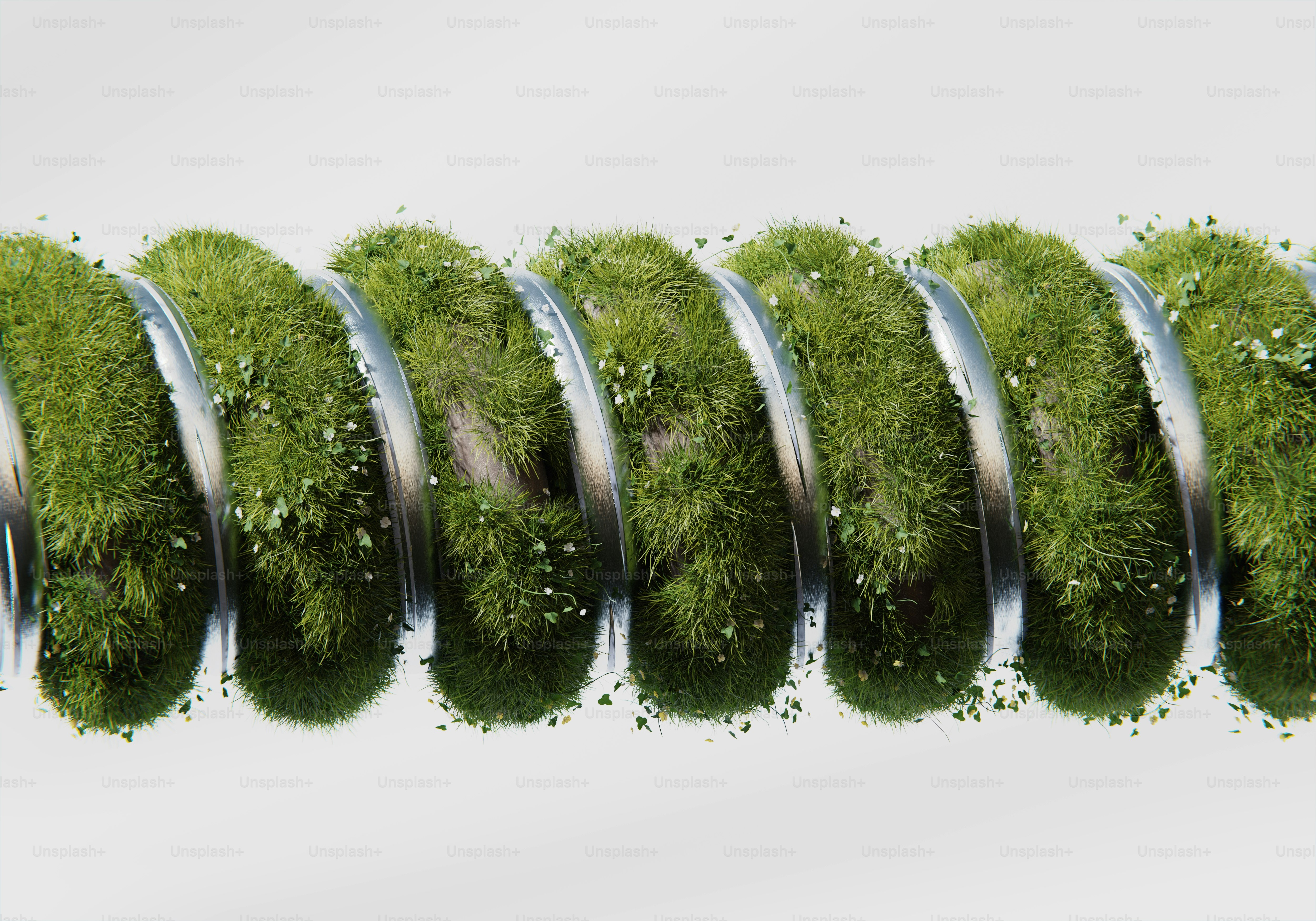 A row of grass covered in metal tubes