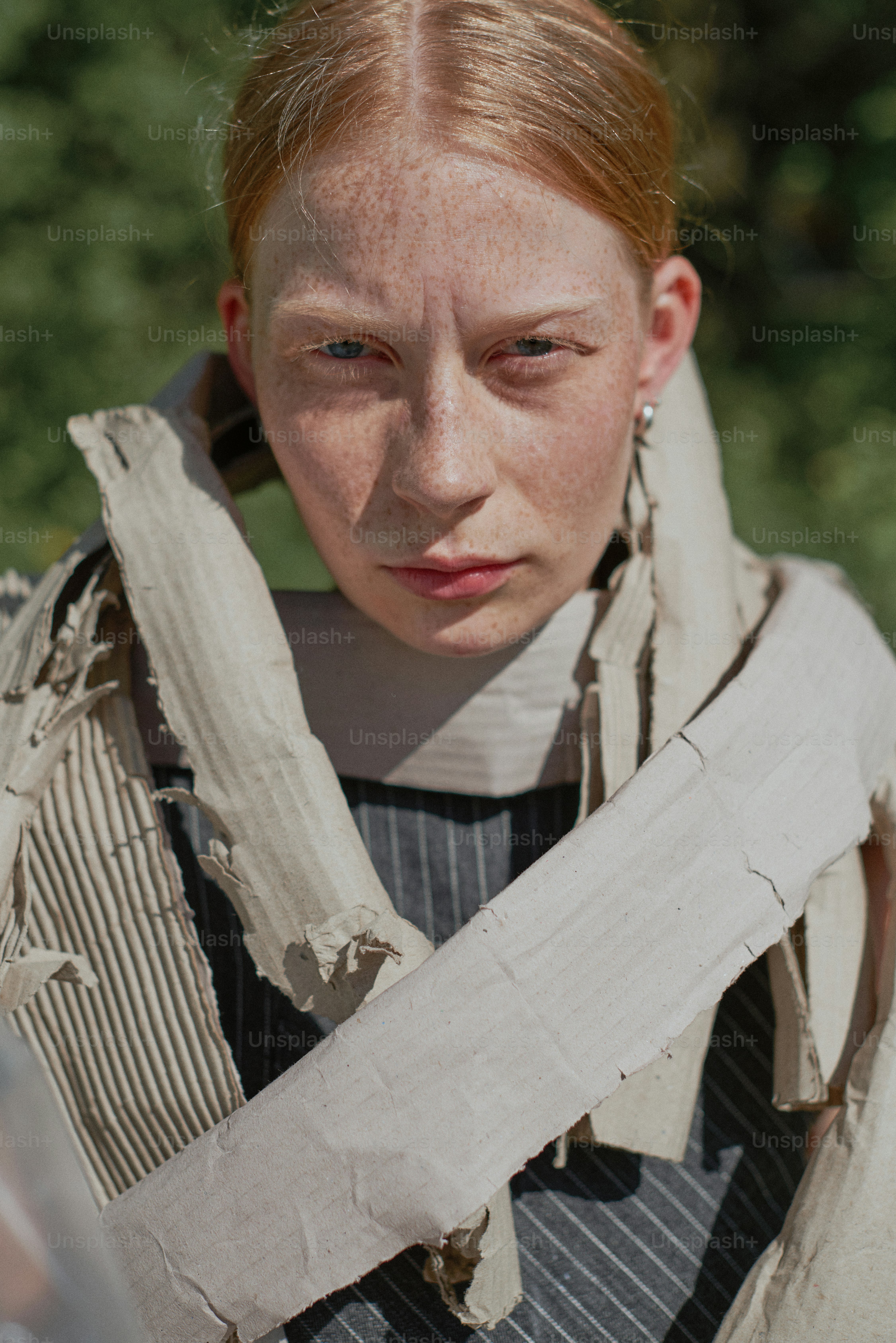 A woman with red hair is holding a piece of paper