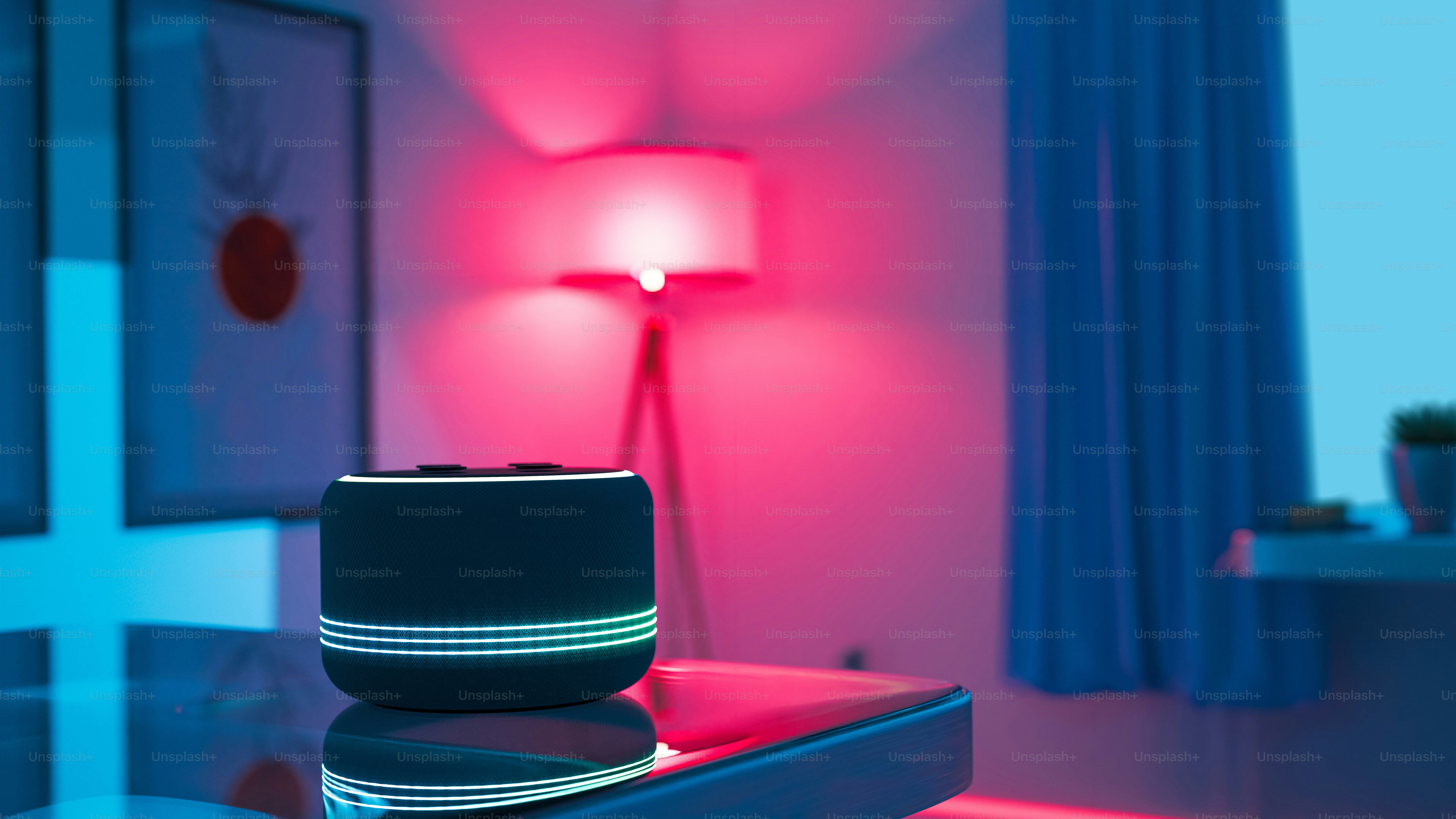 A room with a bed and a table with a lamp on it