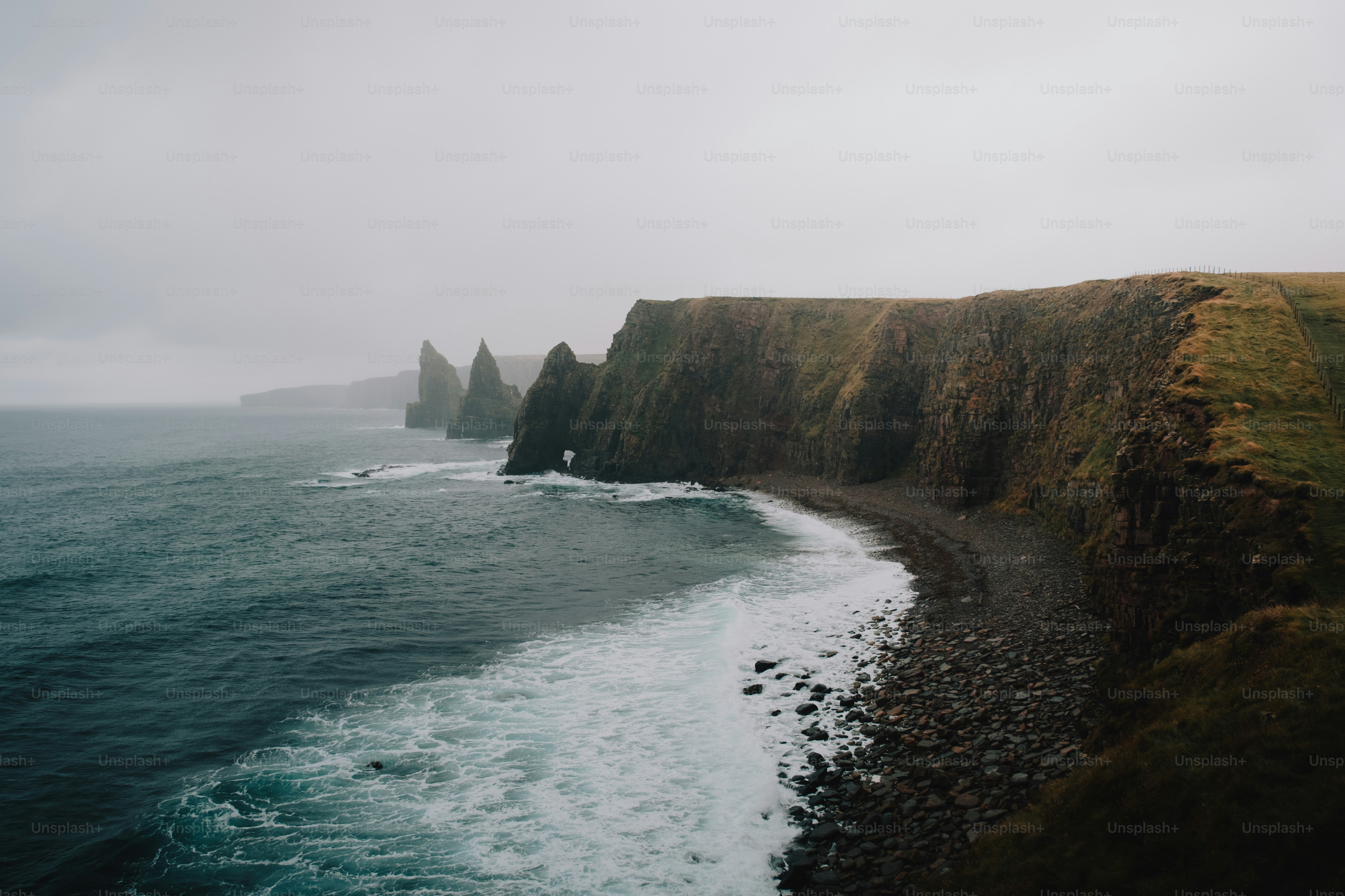 A large body of water next to a cliff