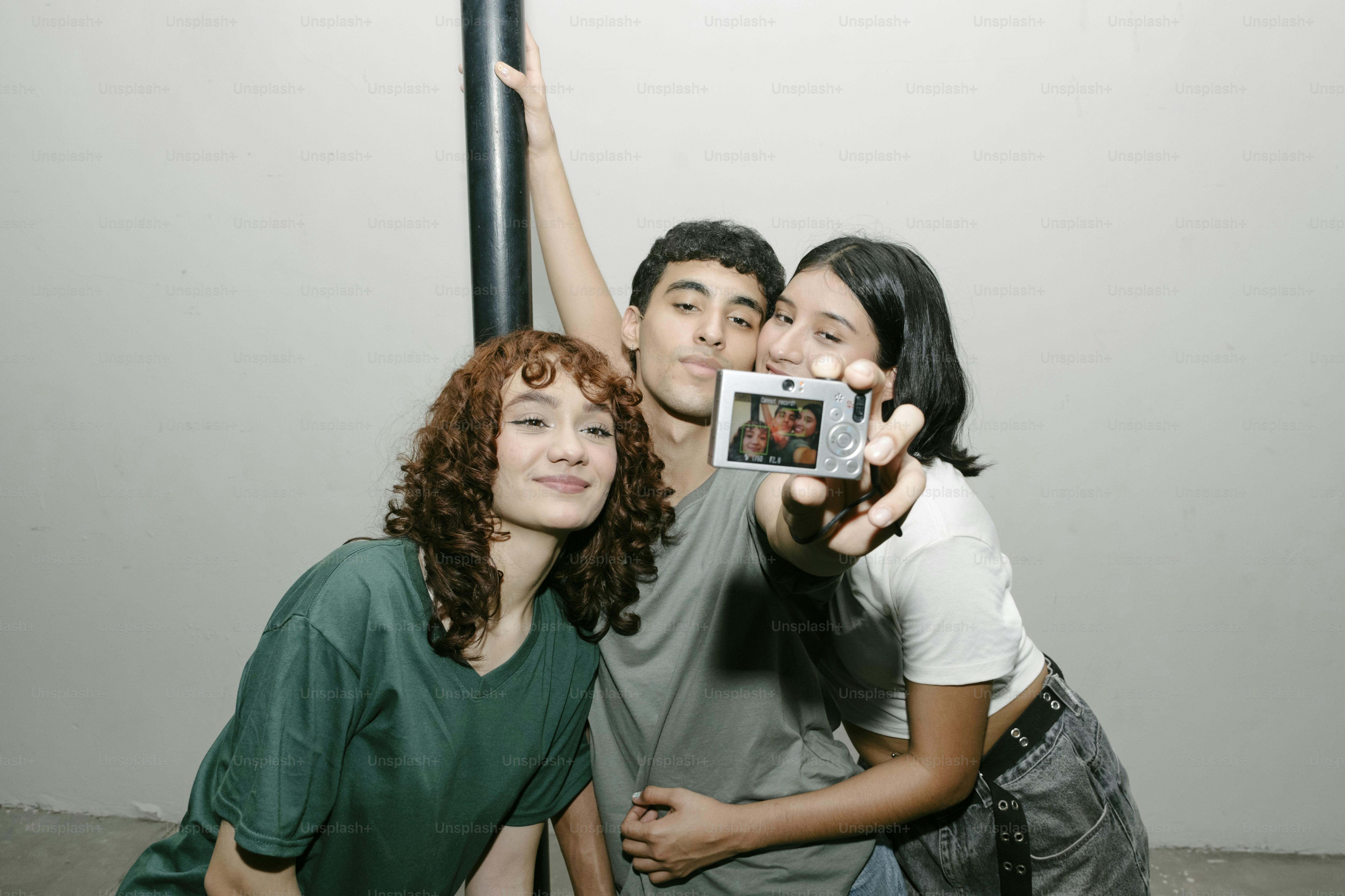 A group of people taking a picture with a camera
