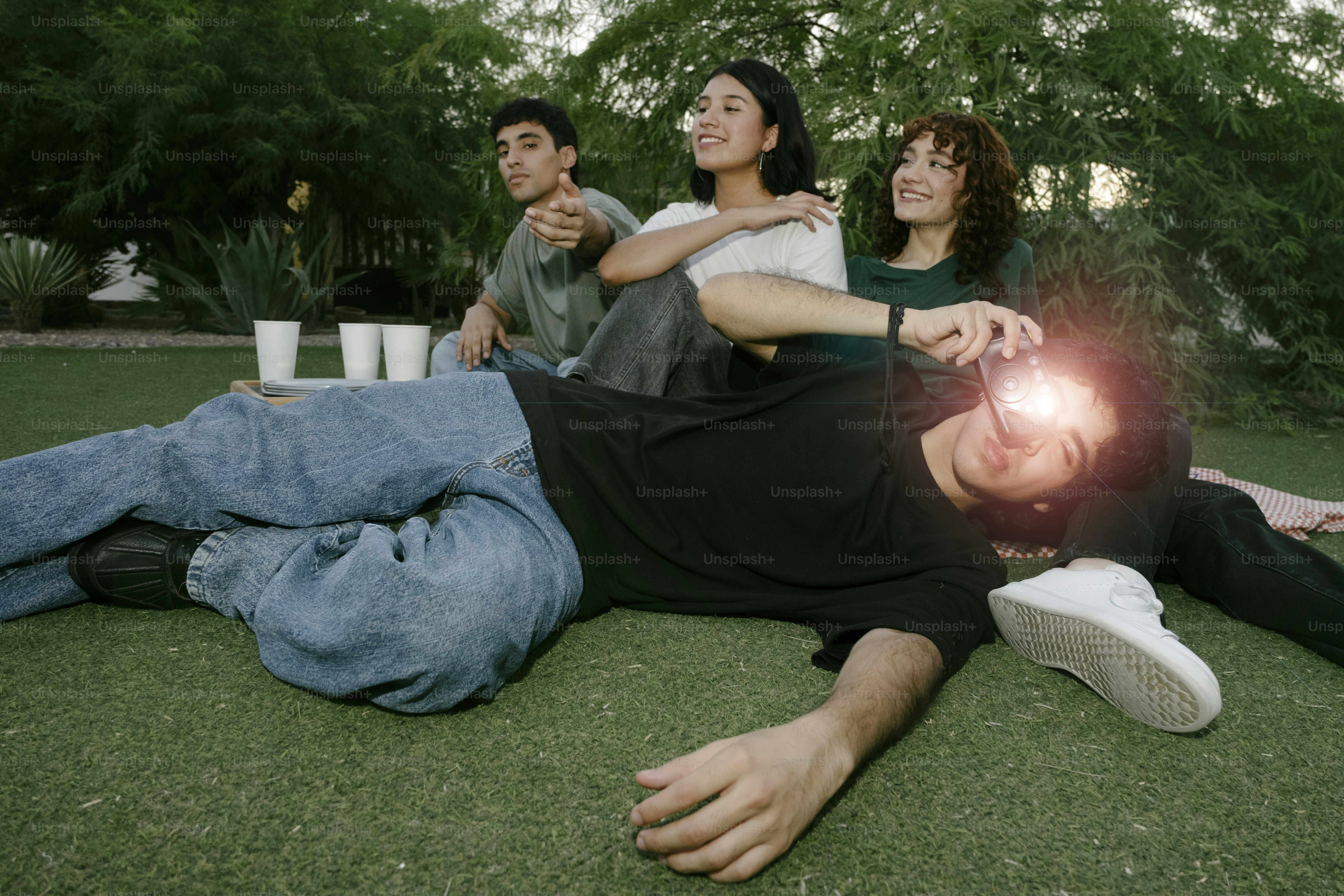 A group of people laying on the grass