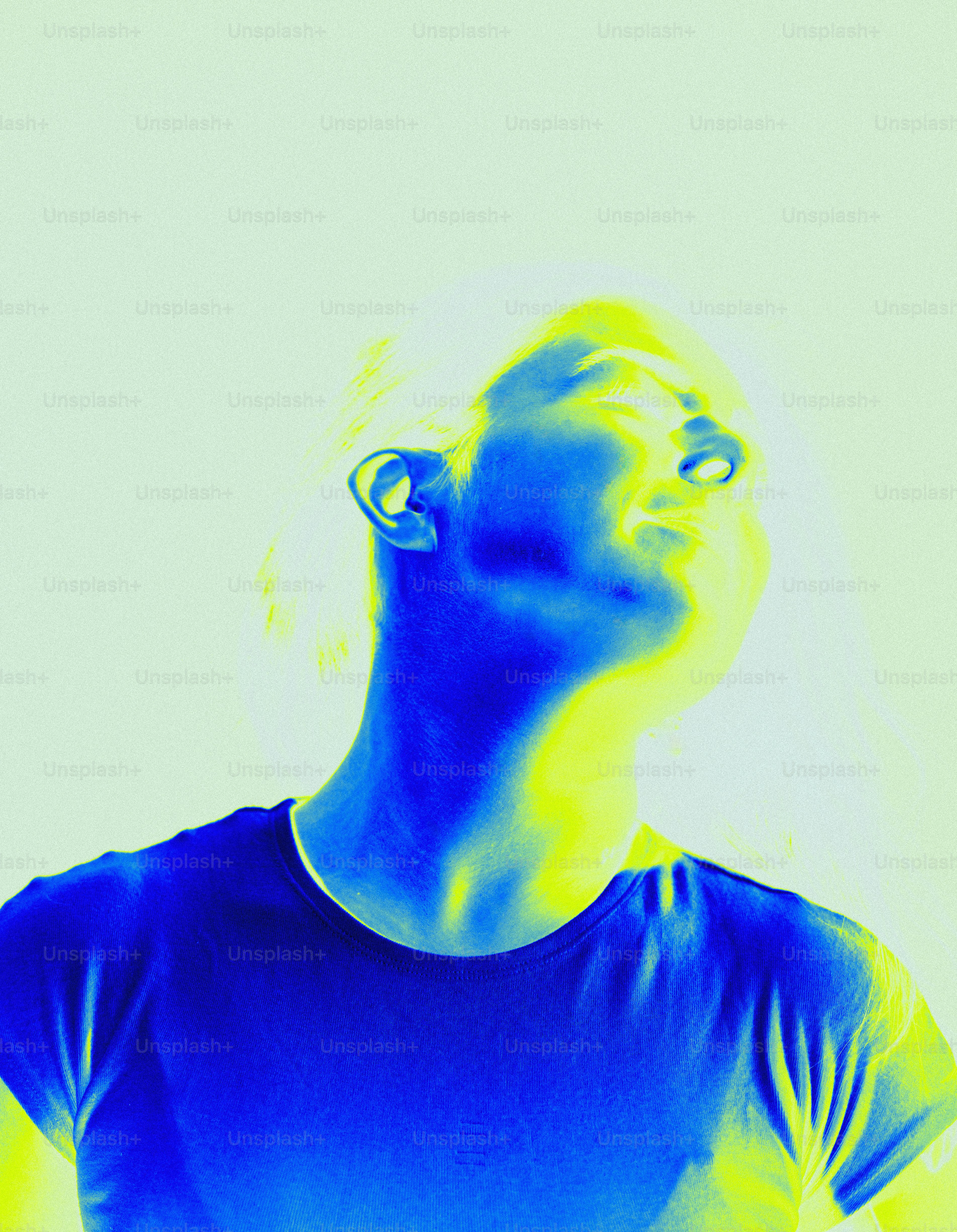 A man in a blue shirt is looking up