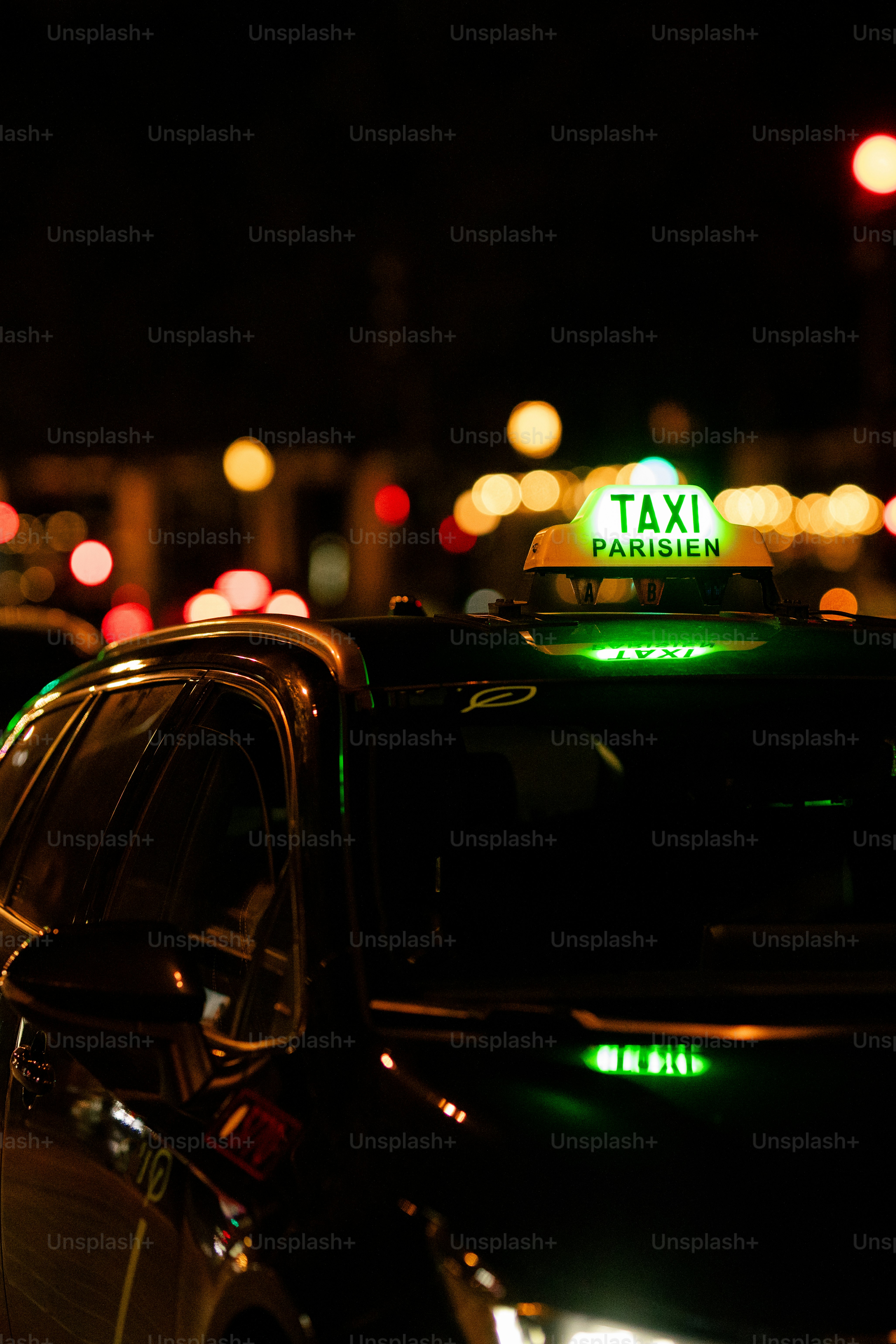 A taxi cab with a green light on top of it