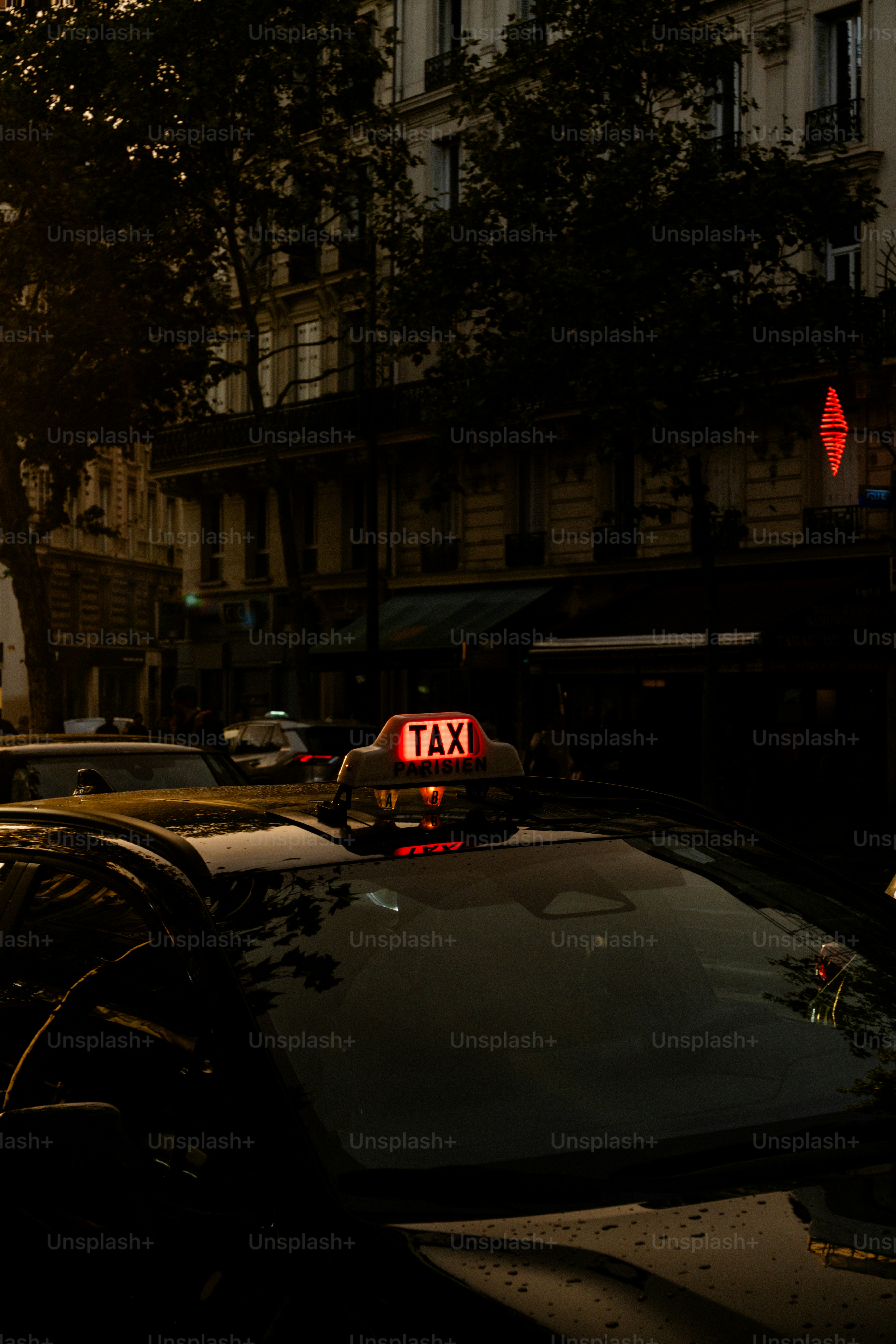 A taxi cab is stopped at a red light