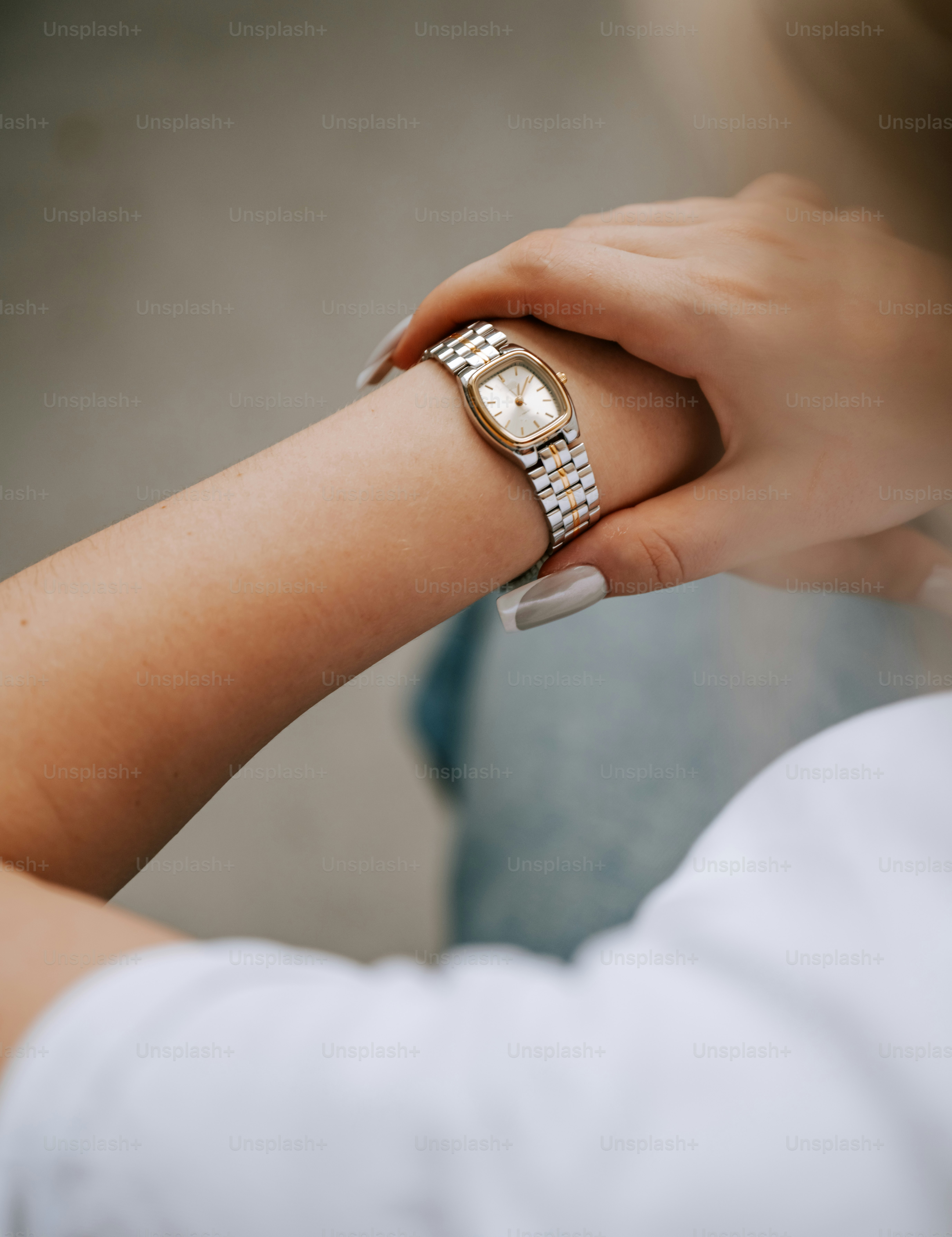A woman wearing a ring on her wrist