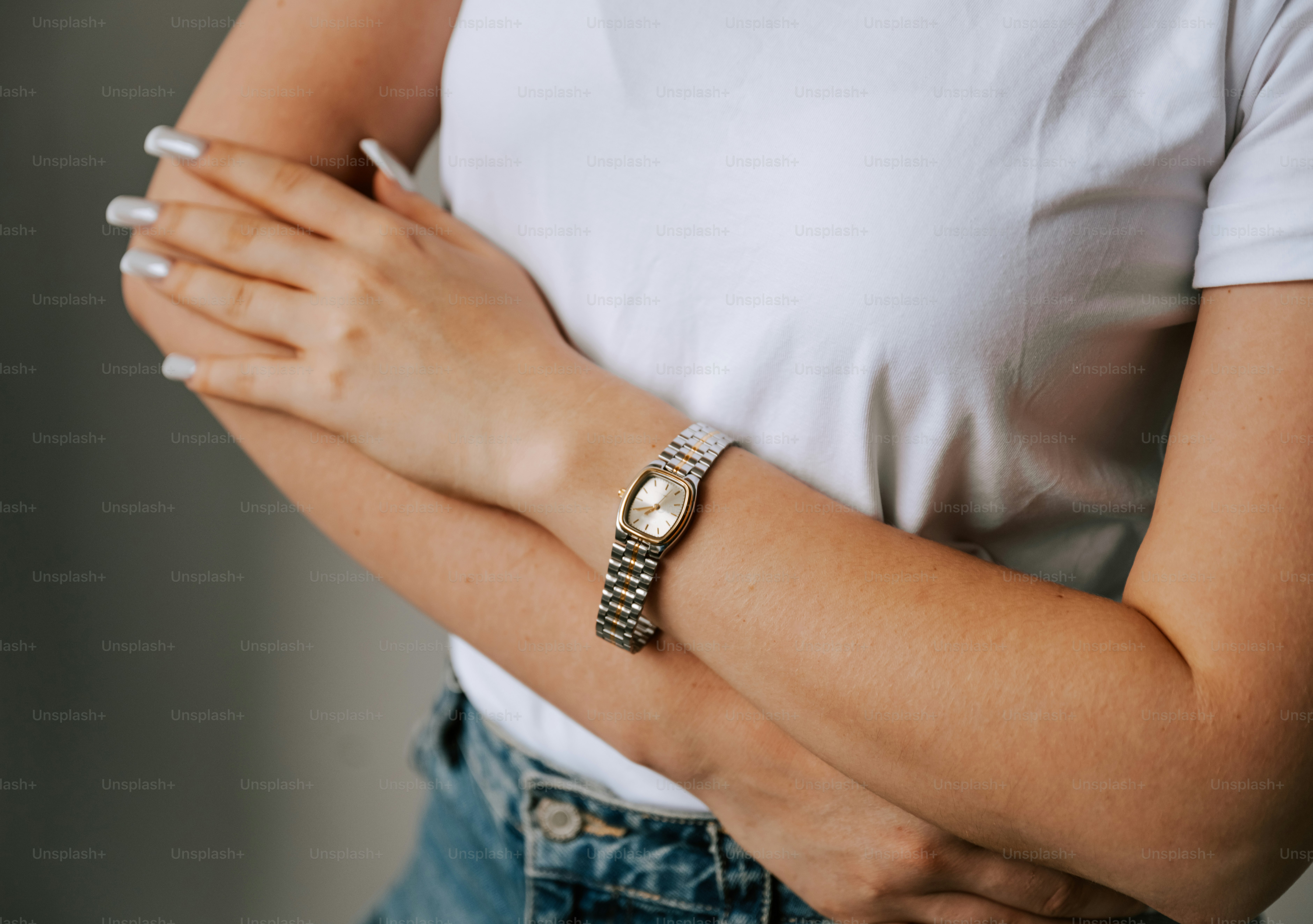 A woman in a white shirt is holding her hands together