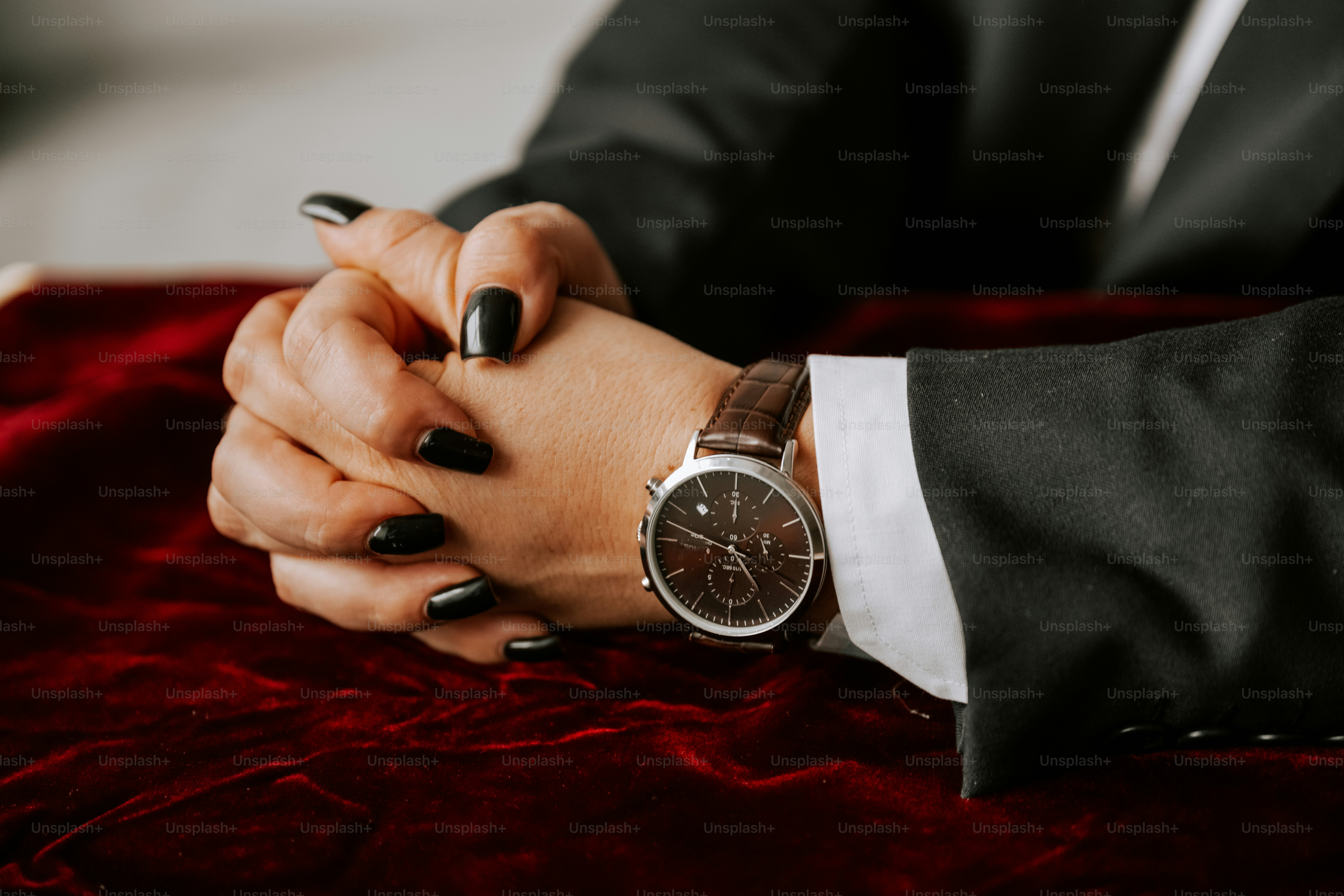 A woman in a tuxedo holding a watch
