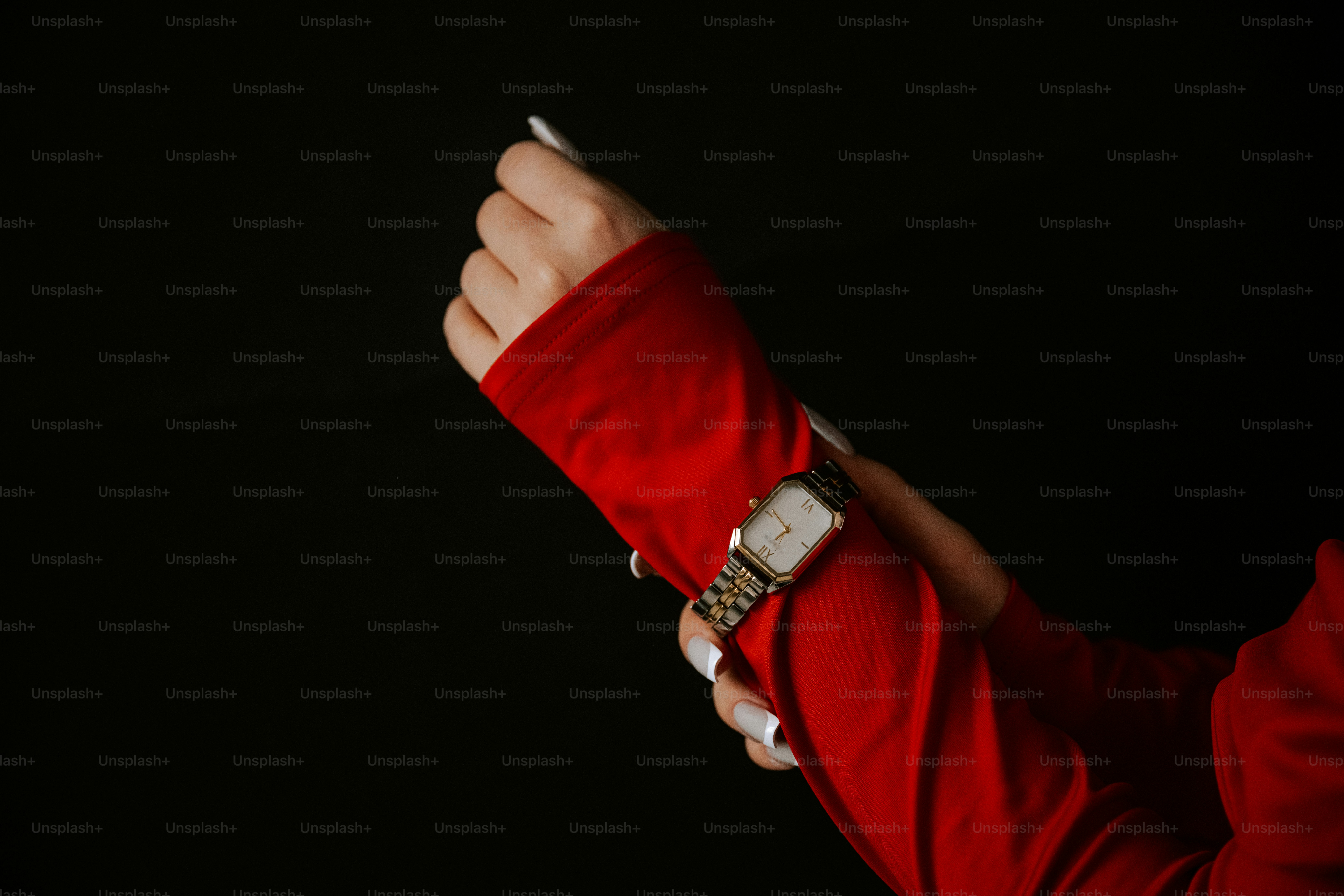 A person in a red shirt holding a cell phone