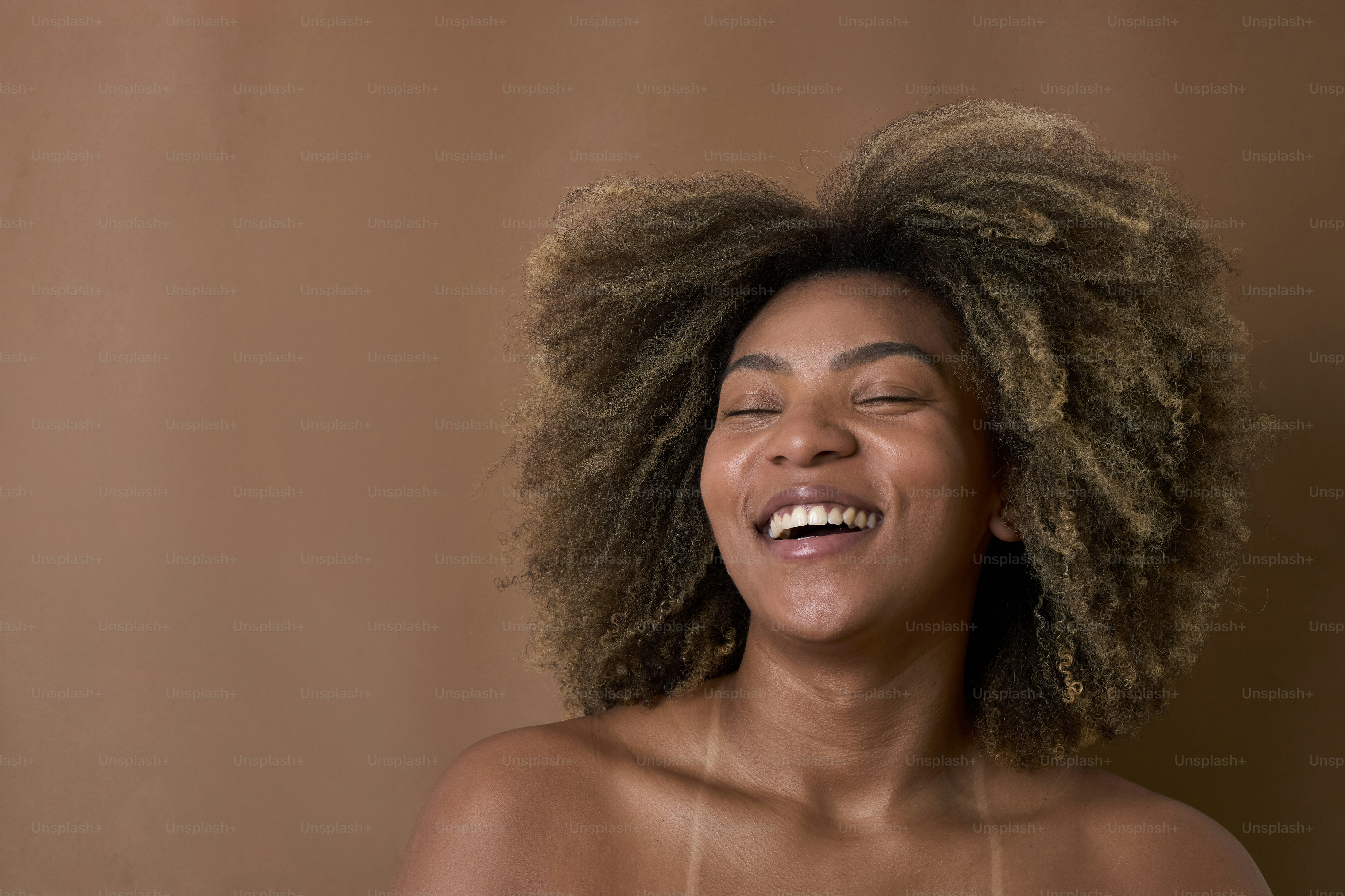 A woman with her eyes closed and her hair blowing in the wind photo ...