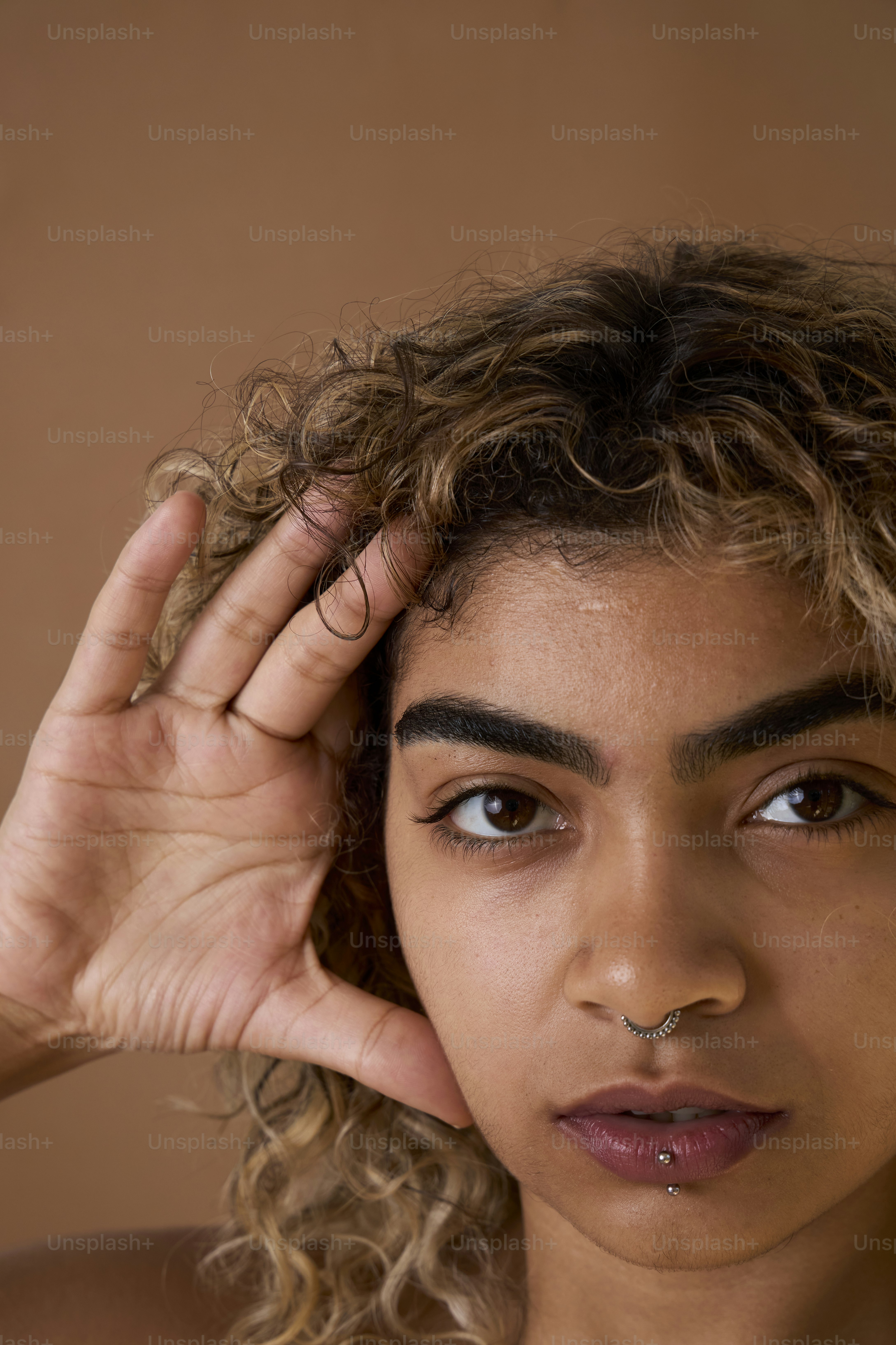 A close up of a person with a nose ring