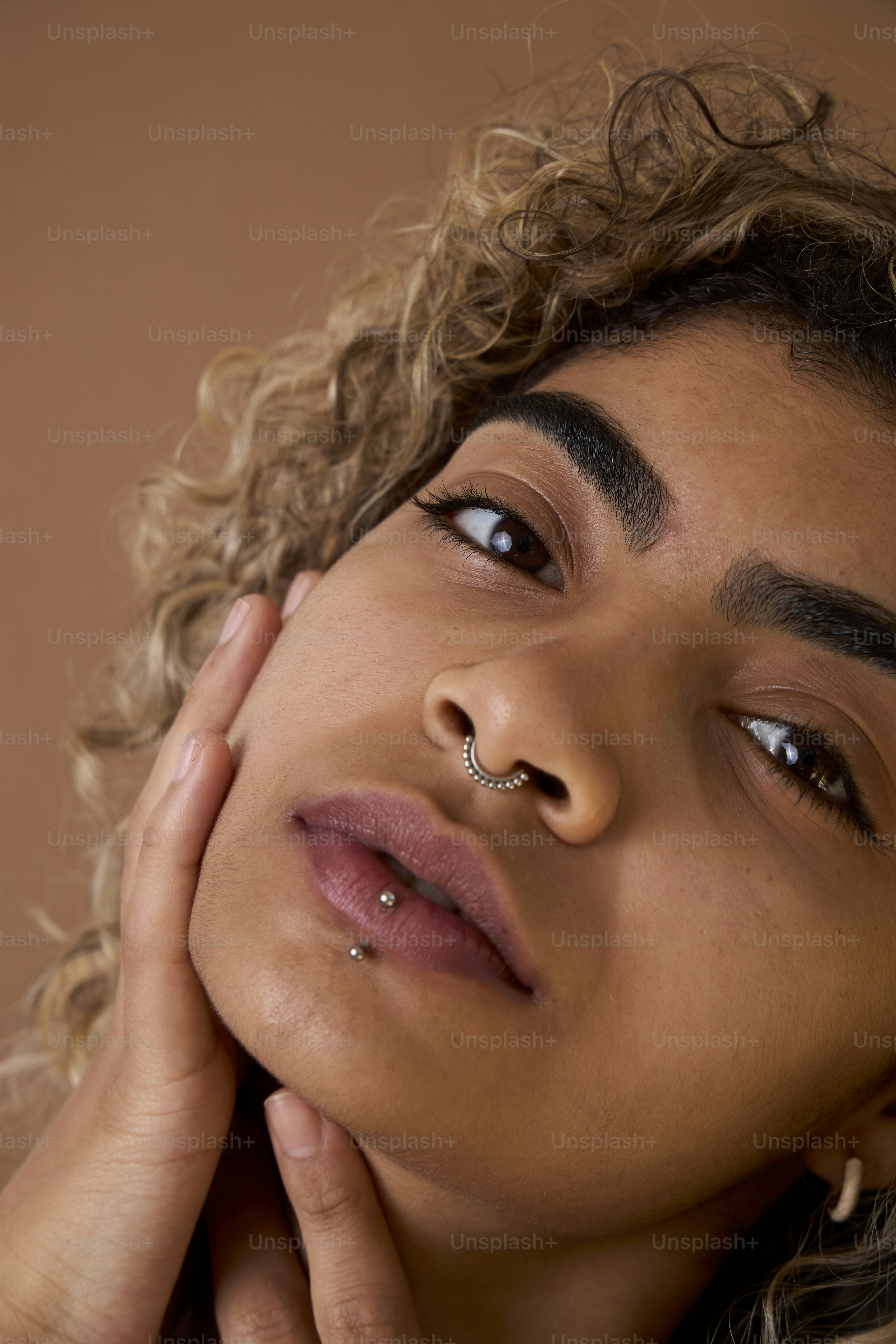 A close up of a person with a nose ring