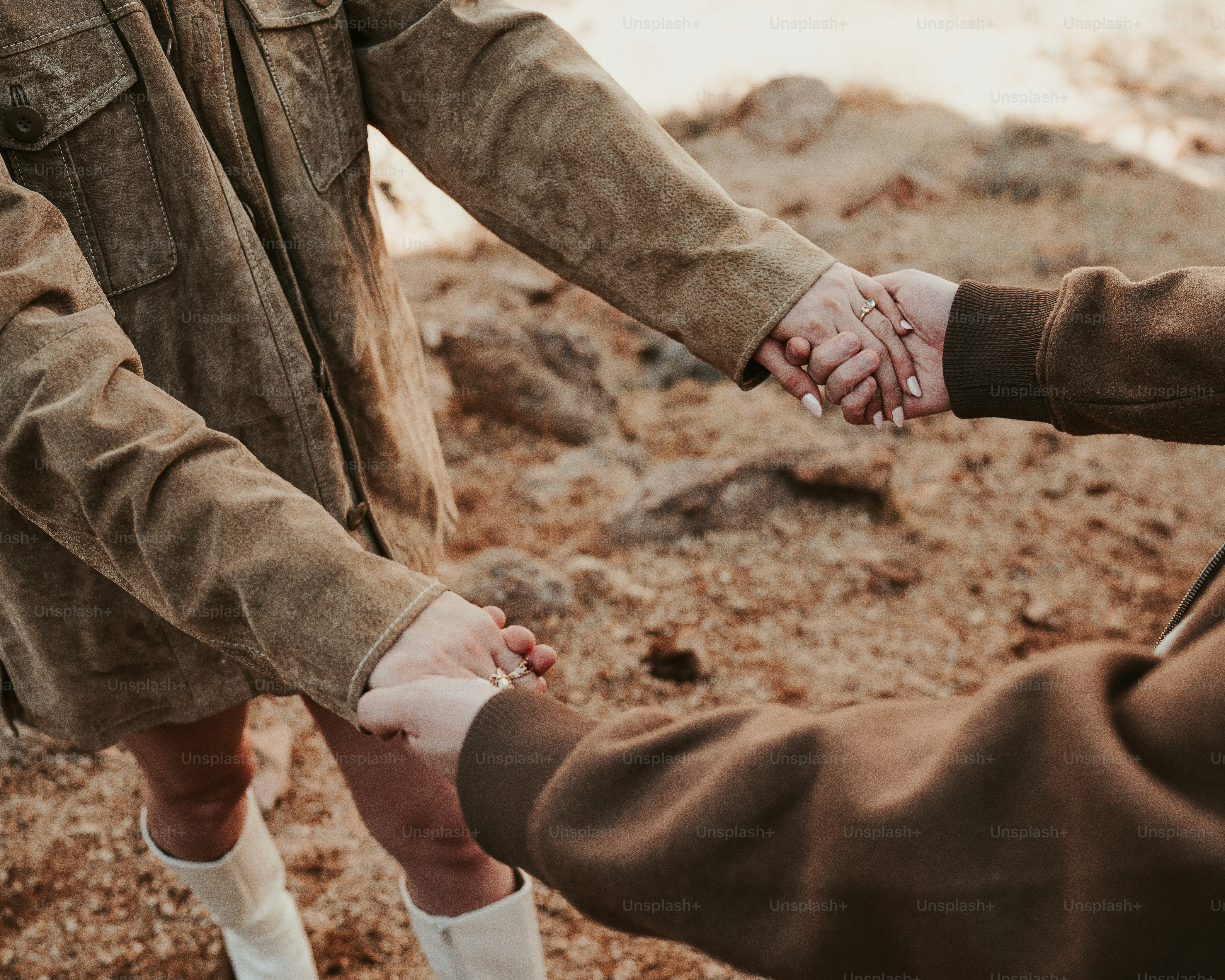 A group of people holding hands in a circle