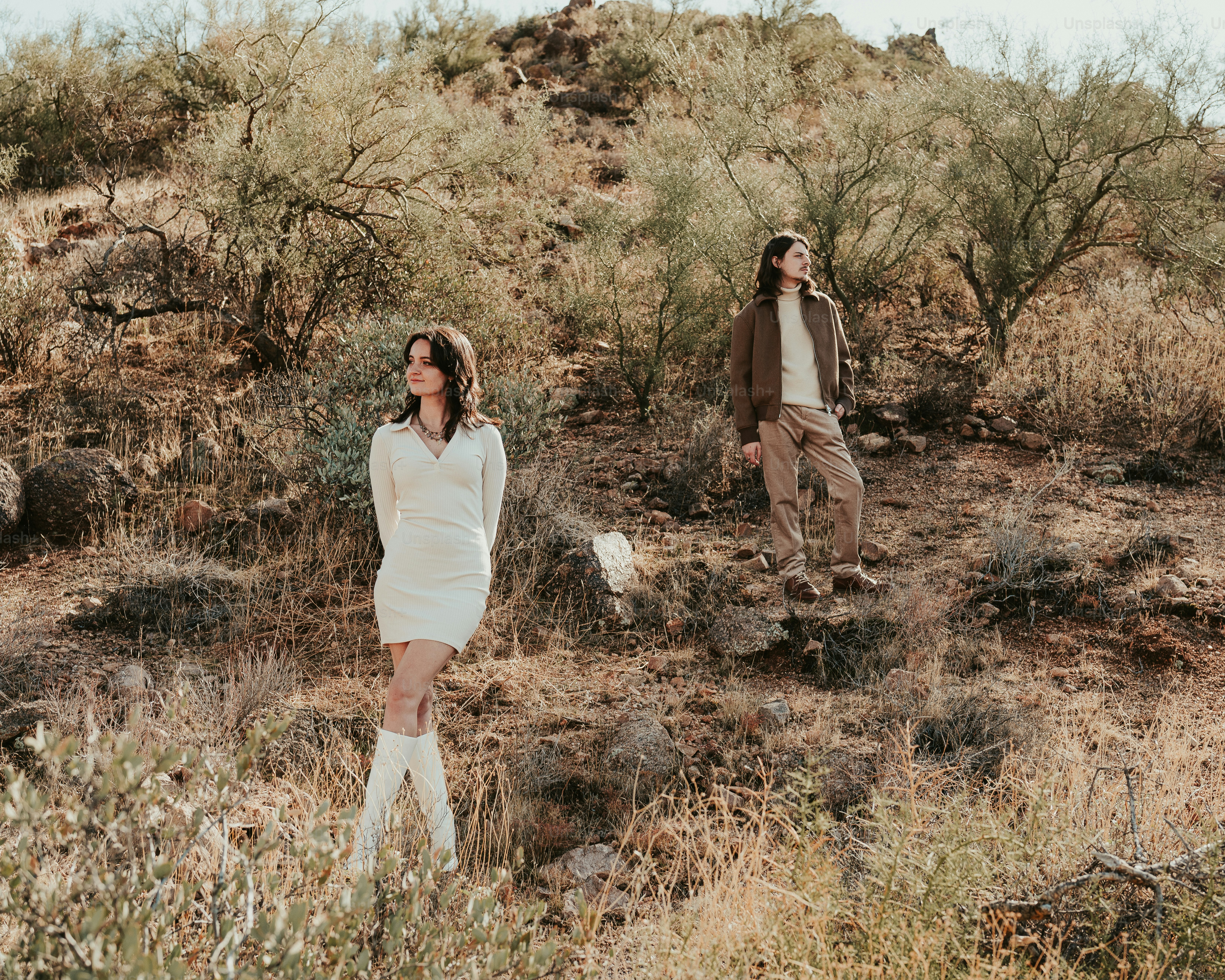 A couple of people standing in a field