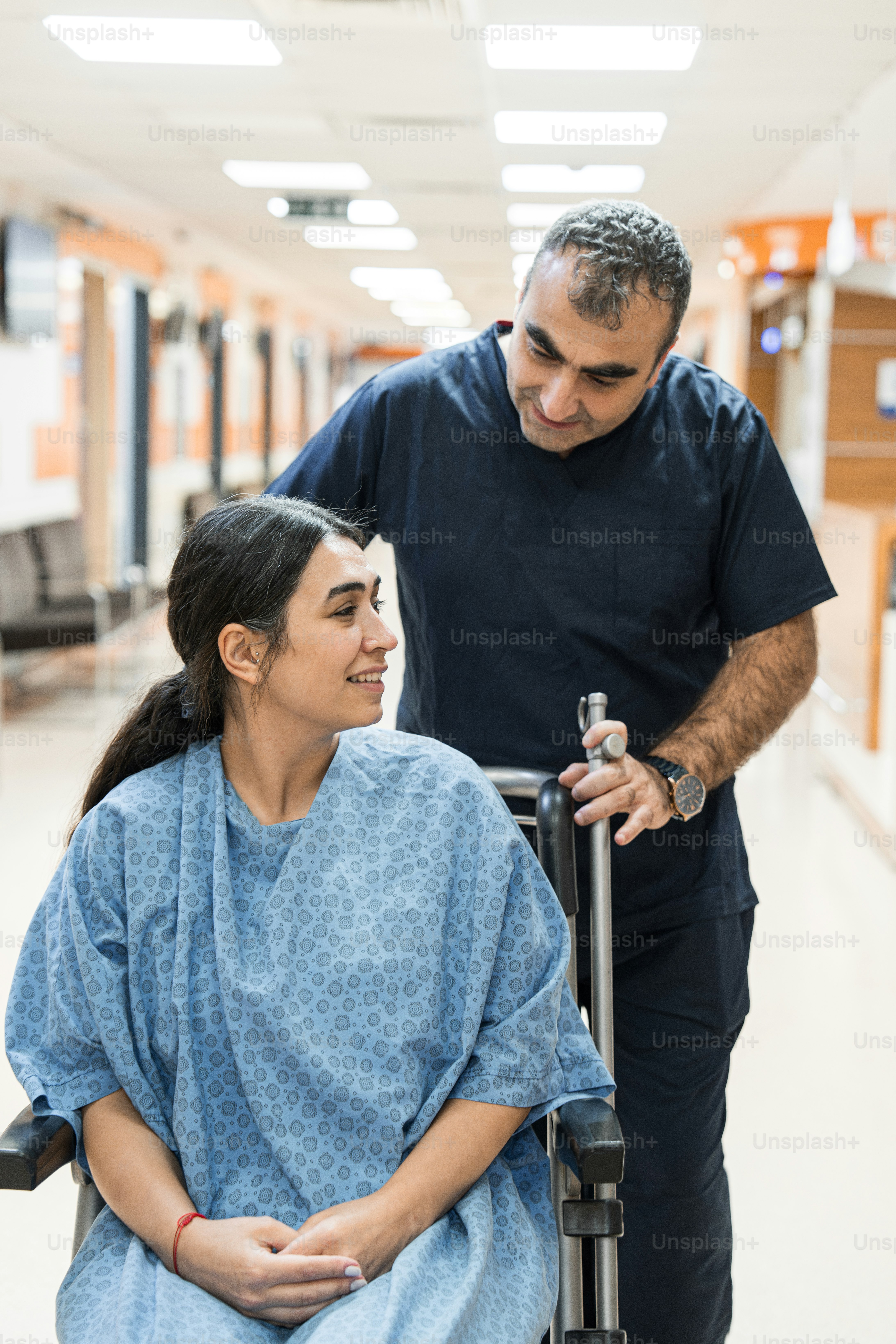 A man pushing a woman in a wheel chair