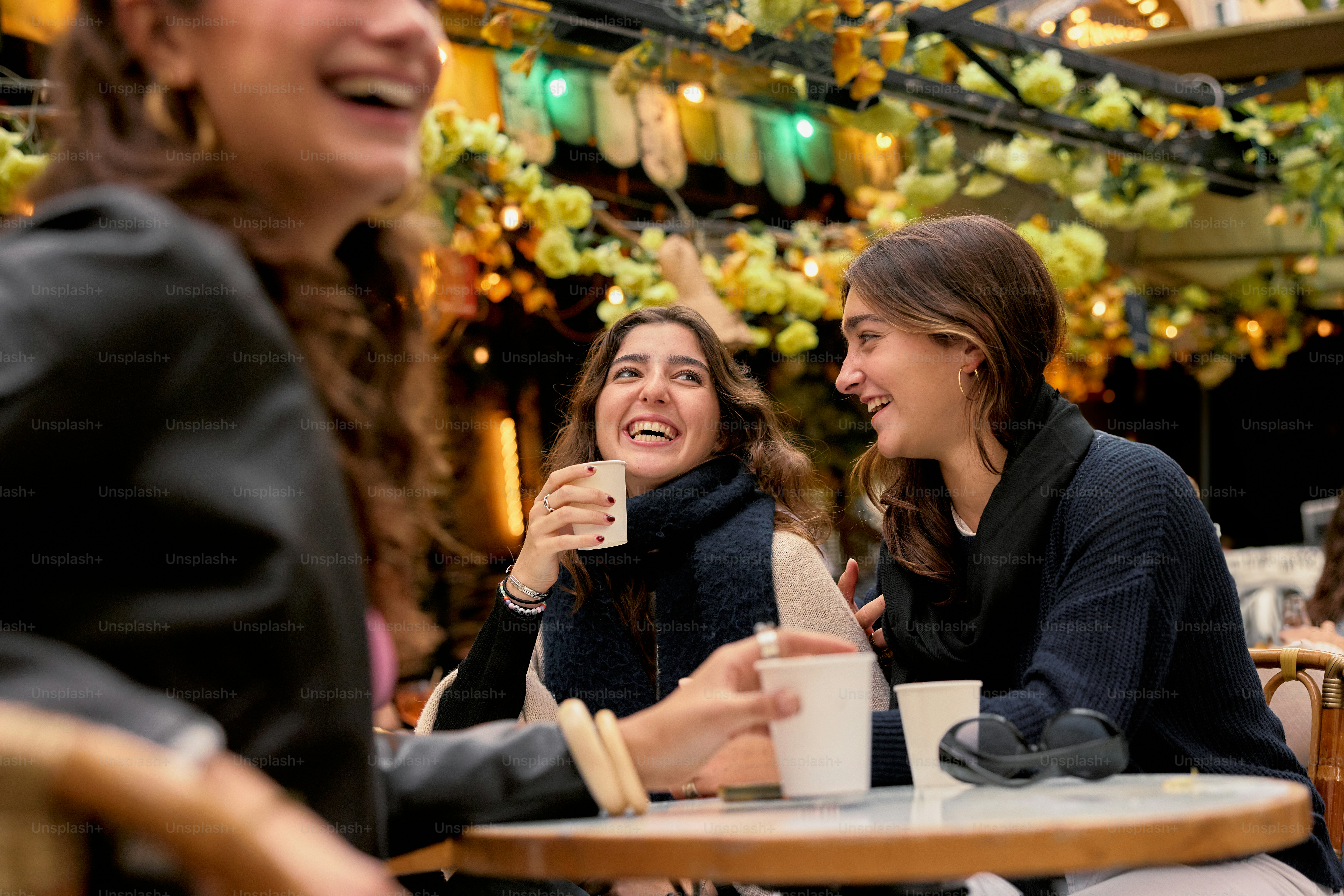A group of women sitting at a table laughing