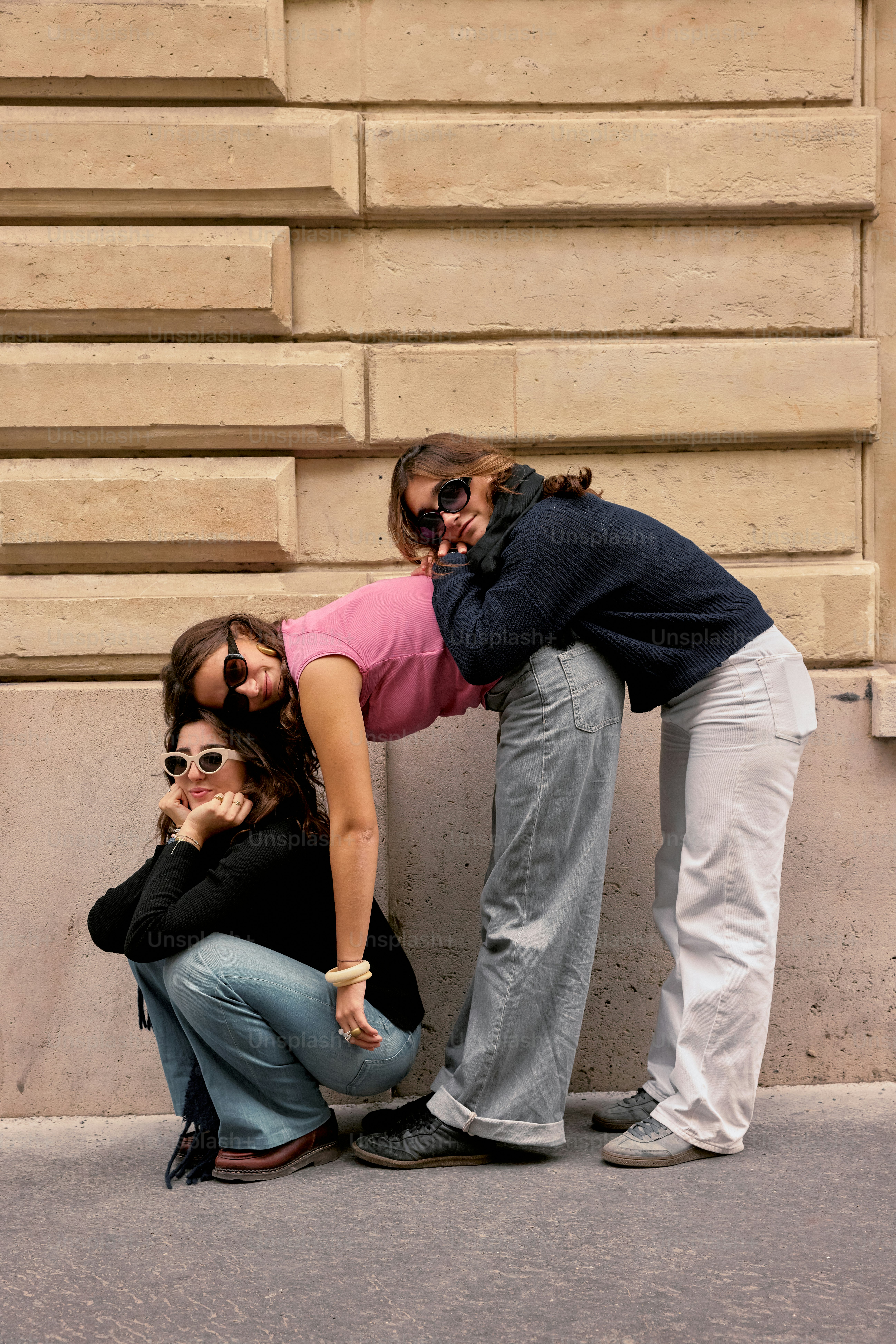 A man and woman leaning against a wall
