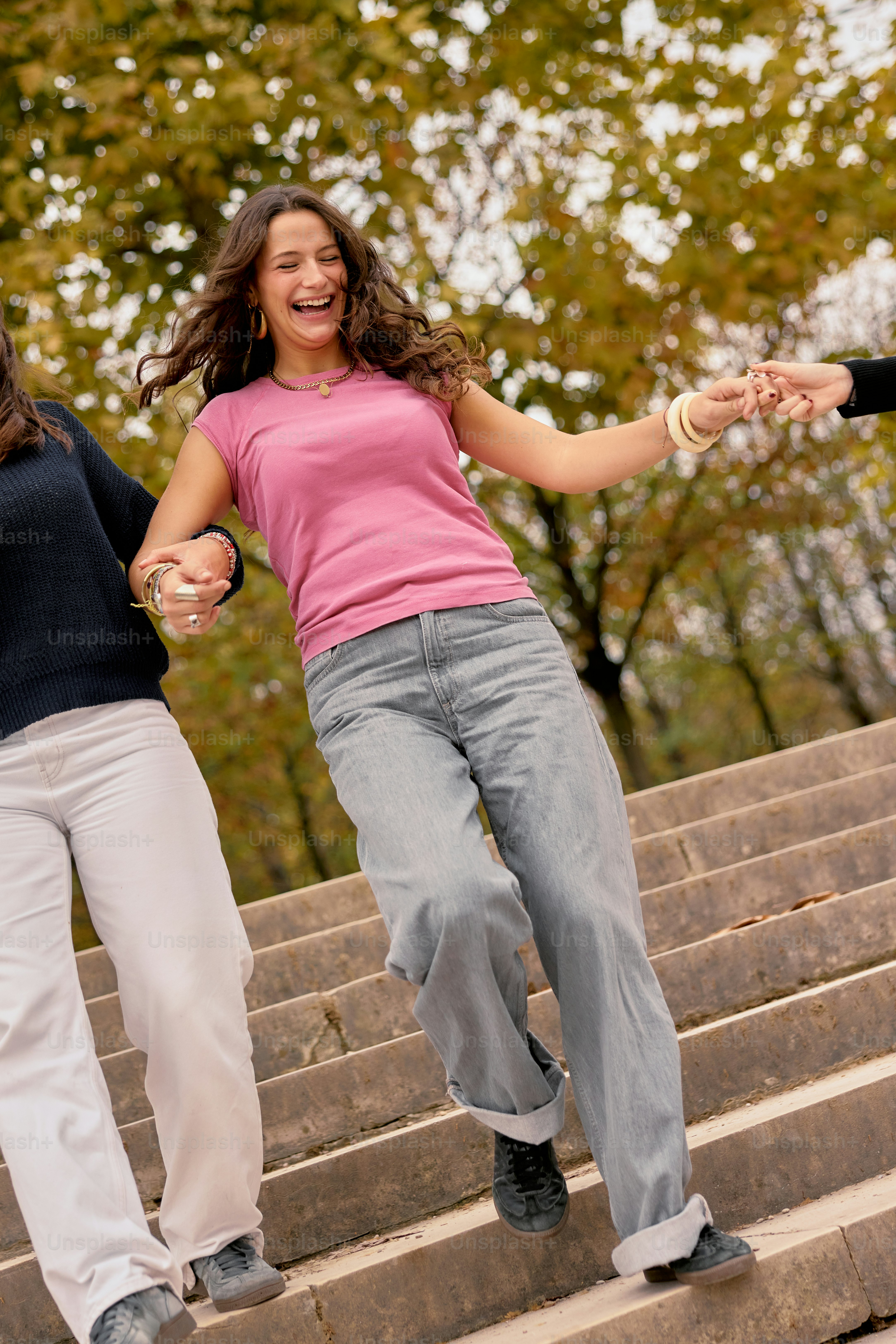 A group of young women running down a flight of stairs