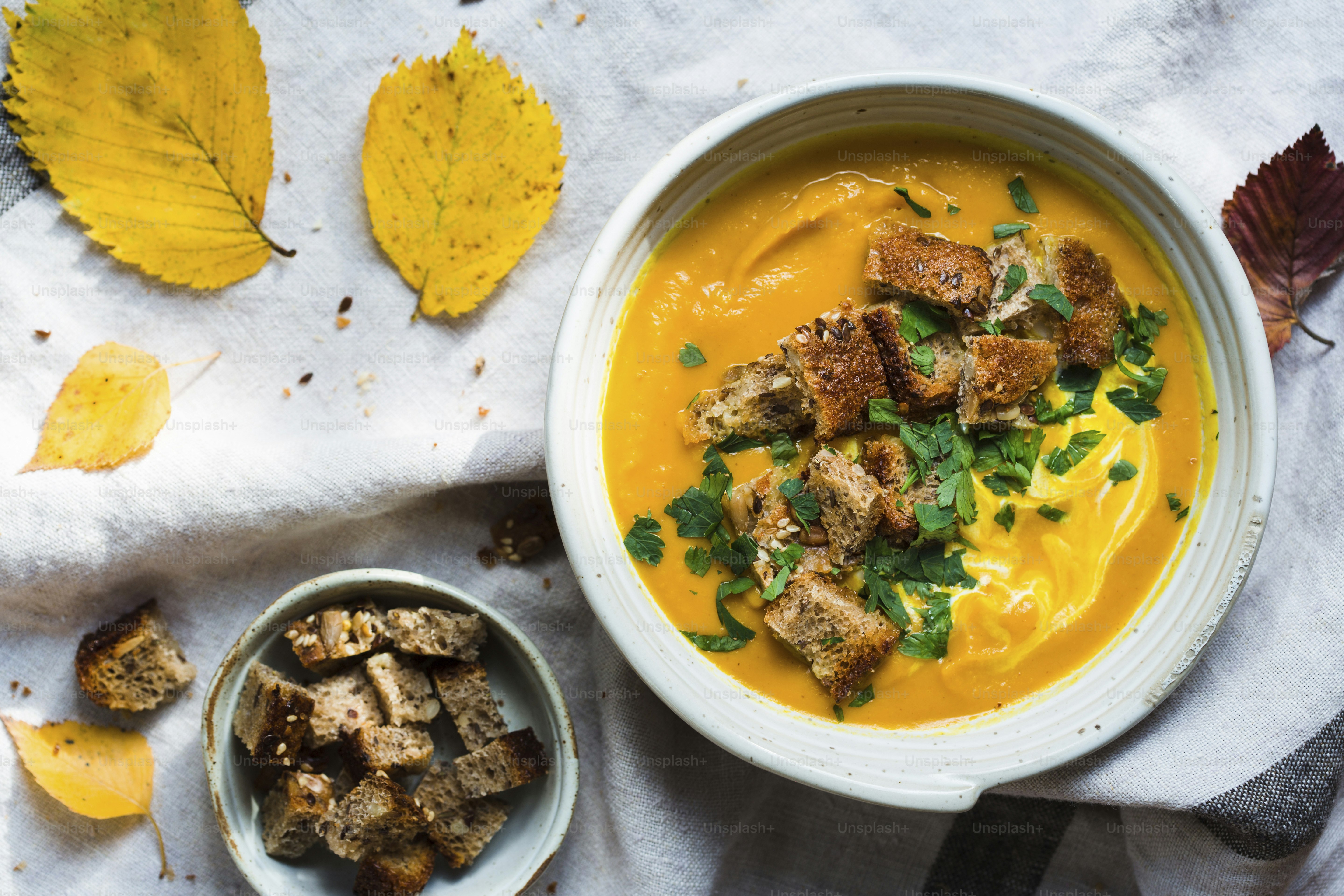 Eine Schüssel Suppe und eine Schüssel Brot auf einem Tisch