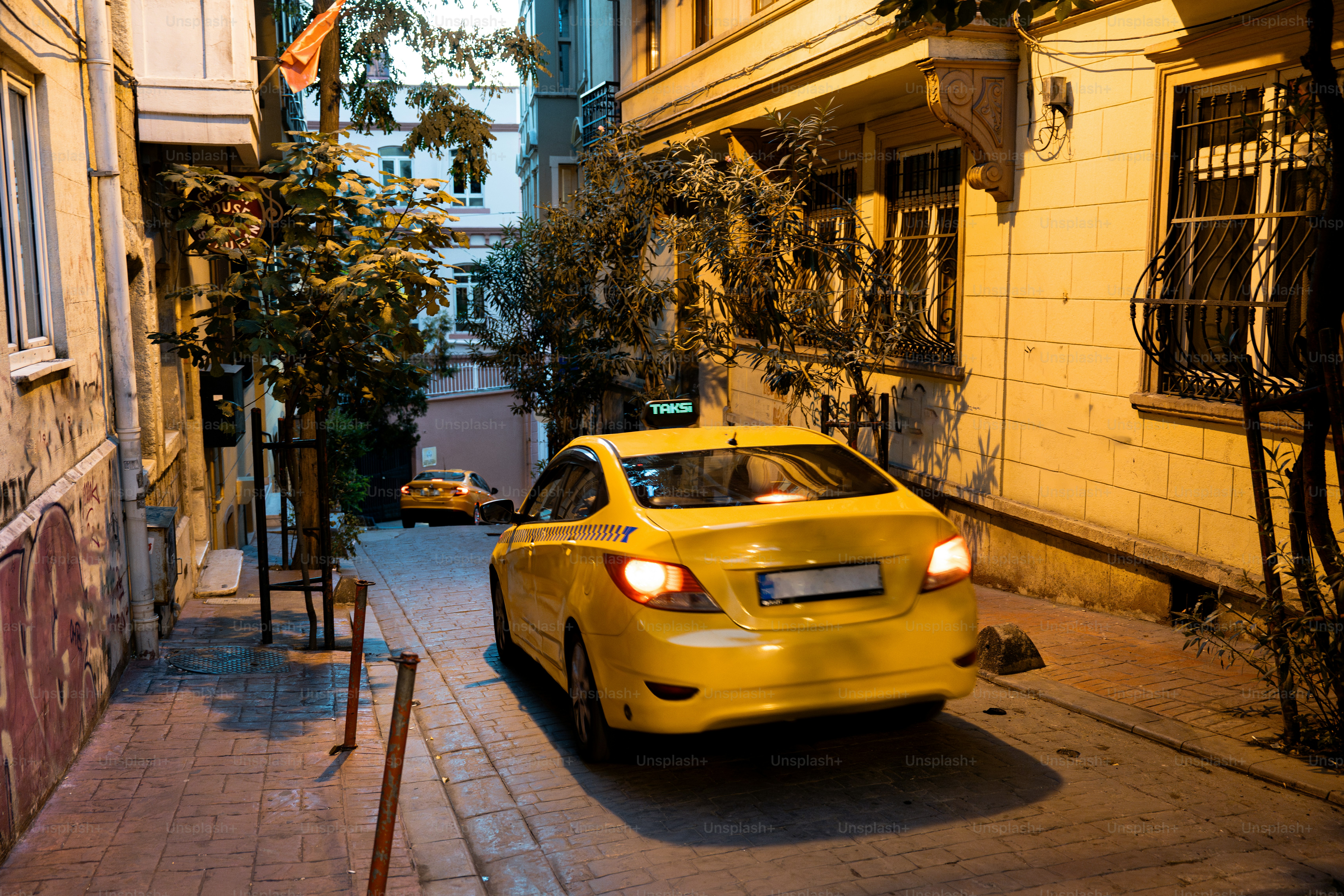 A yellow car parked on the side of a street
