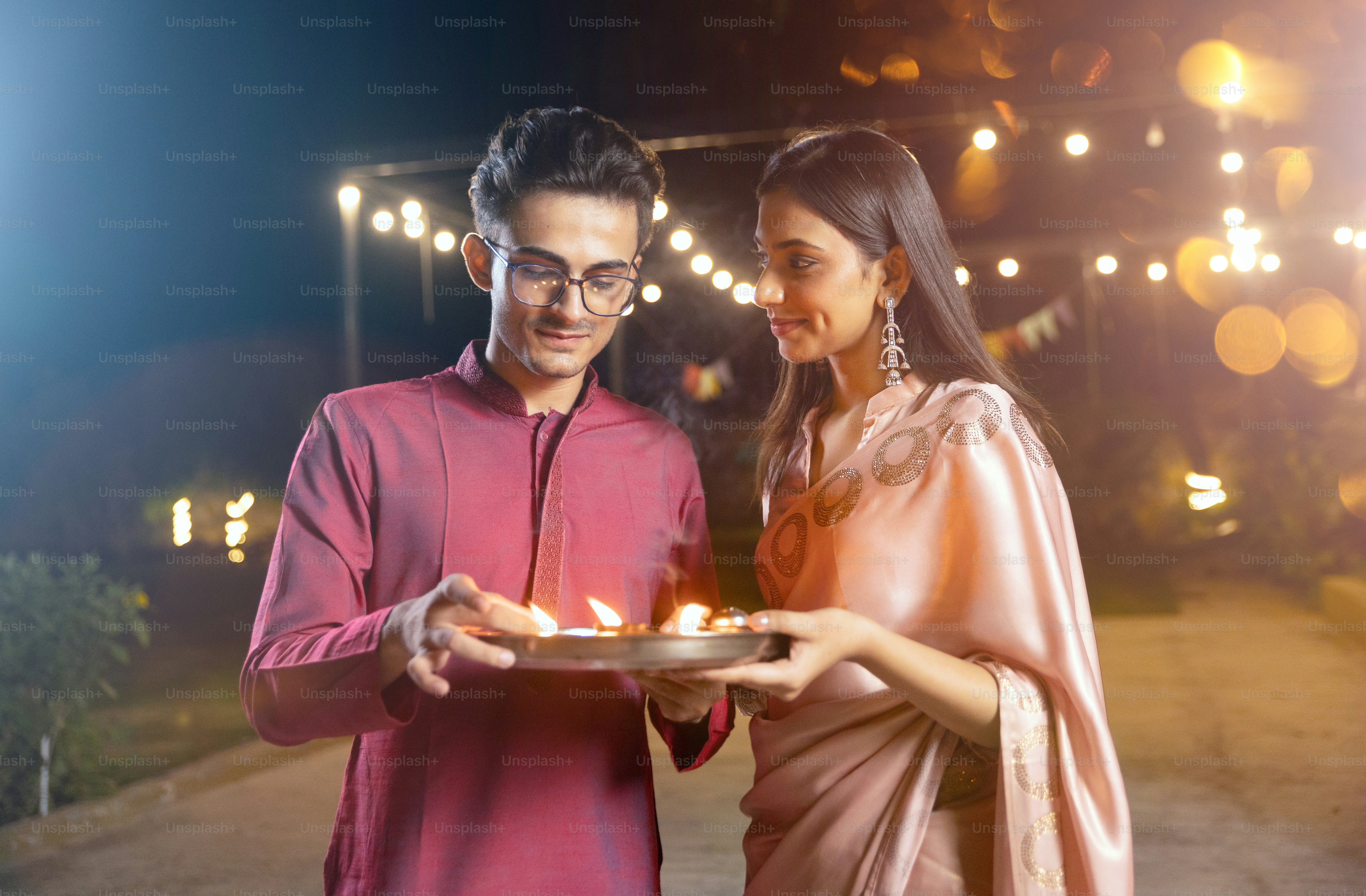 A man and a woman holding a plate of food